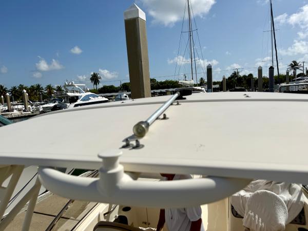 2016 Scout 245 Dorado boat roof detail at marina, clear sky background.