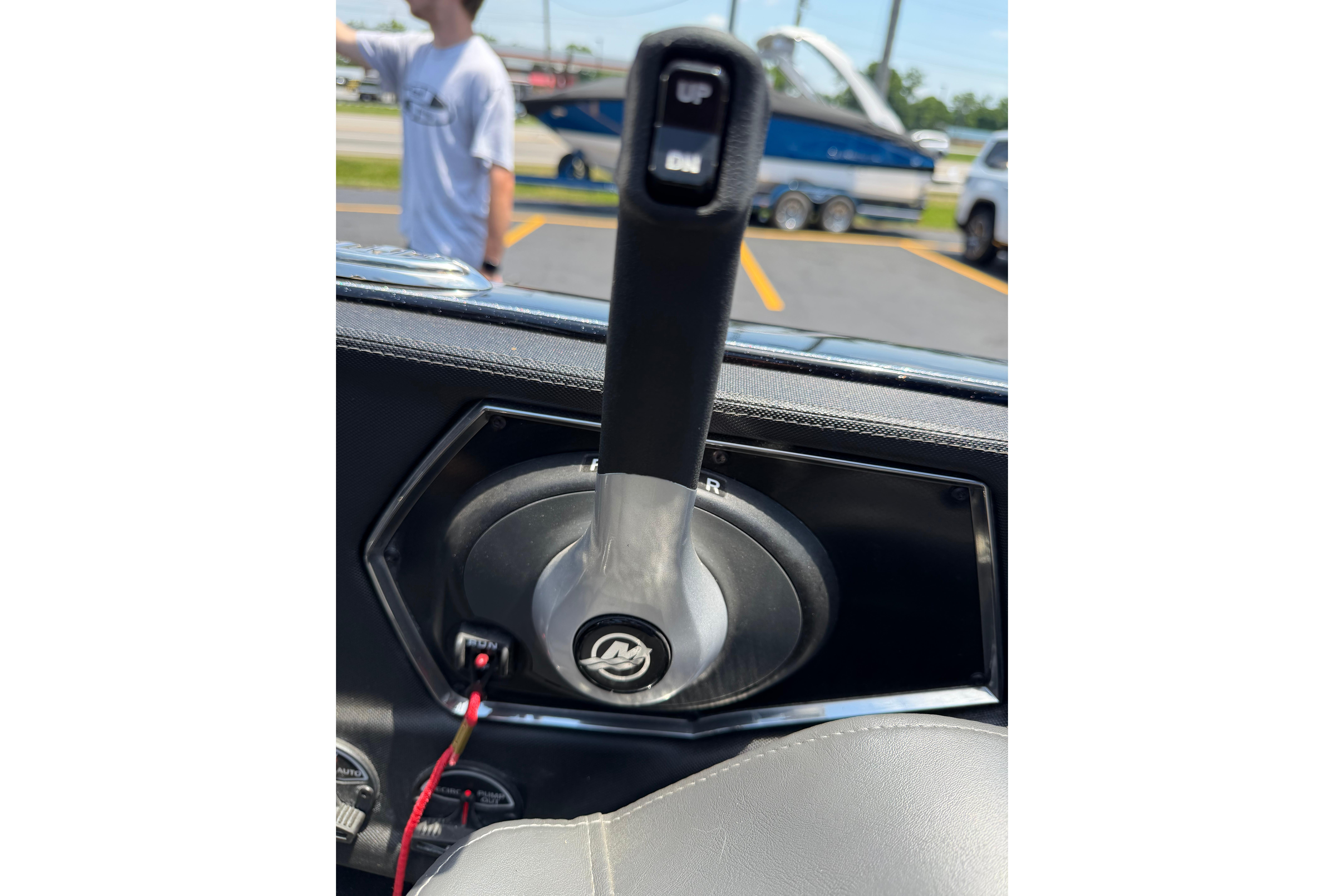 2023 Ranger Z520R boat throttle control with trim switch, parking lot background.