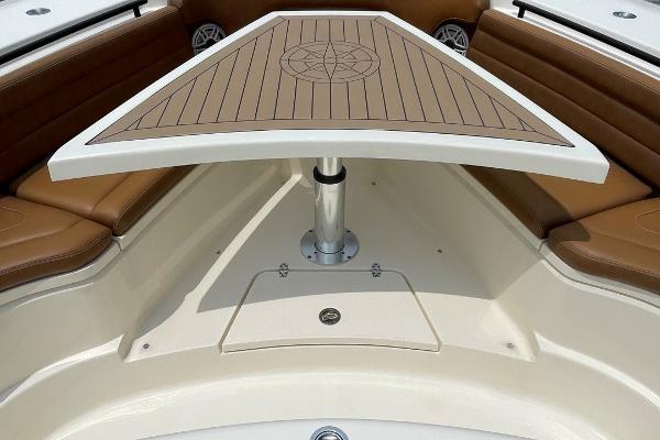 2020 Scout 420 LXF boat interior with brown seating and a wooden table.