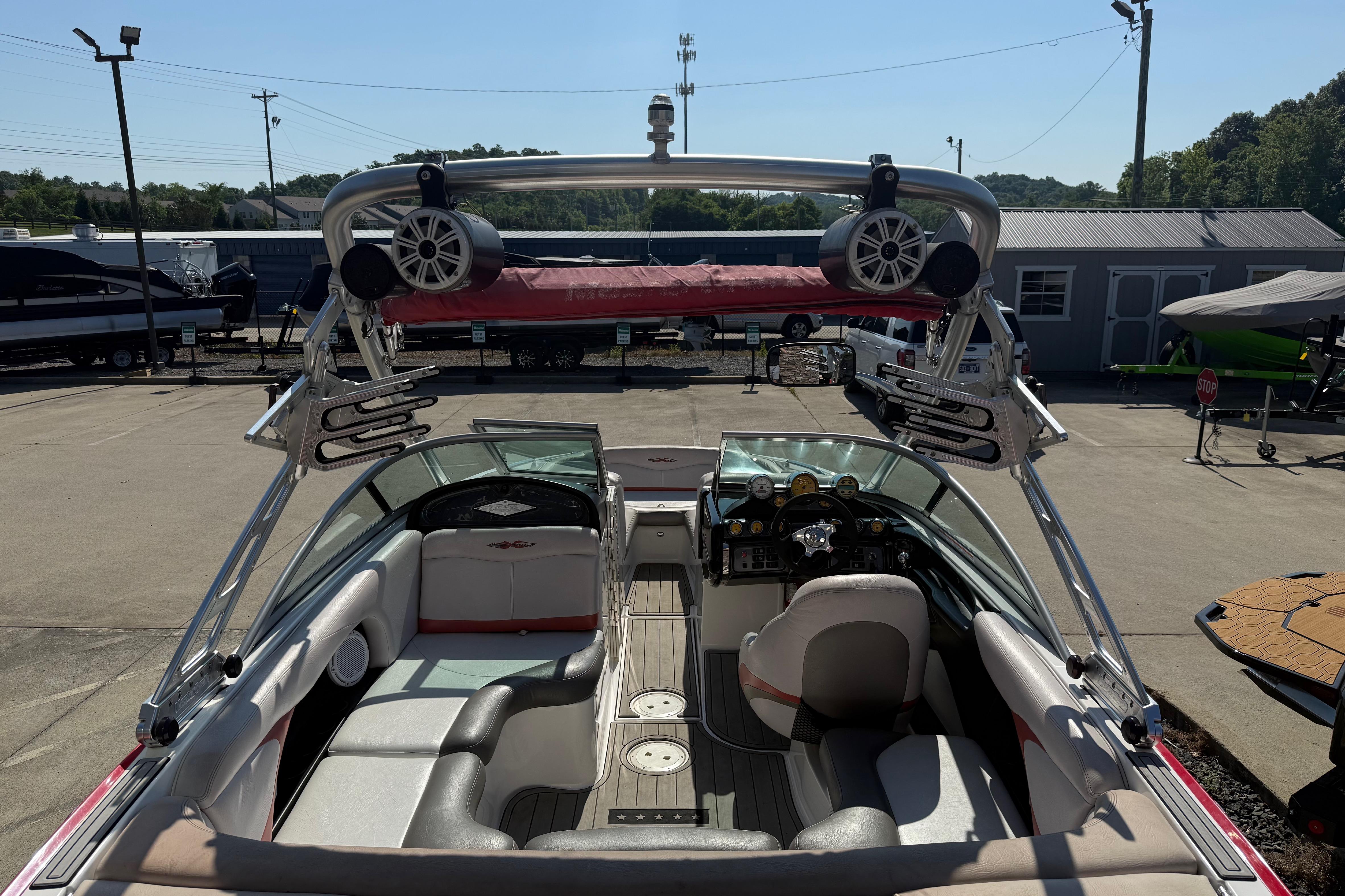 2005 MasterCraft XStar boat interior with speakers and seating, parked in a marina.
