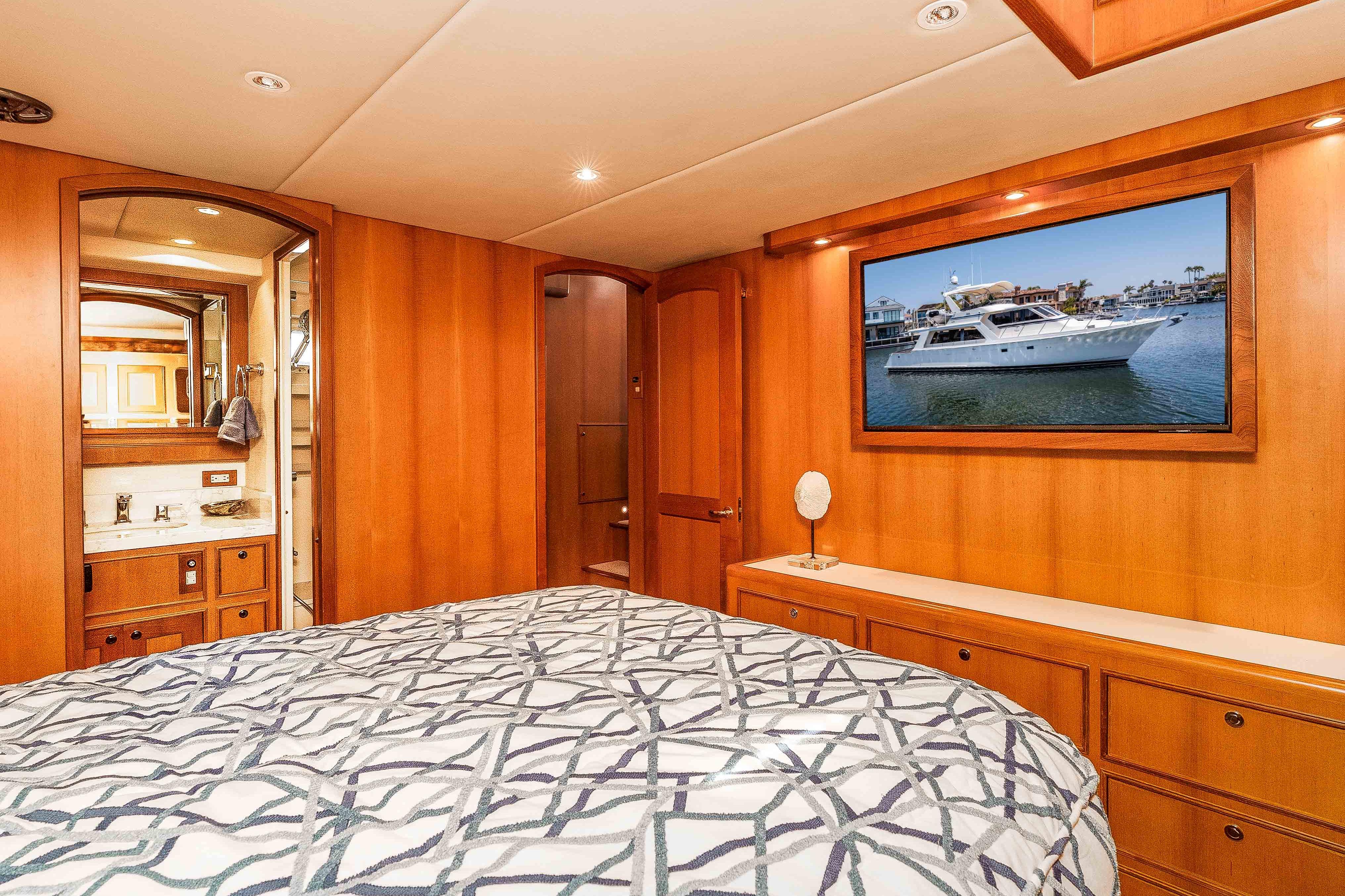Luxurious 2005 Offshore Yachts 54 Pilothouse bedroom with elegant wood paneling and modern amenities.