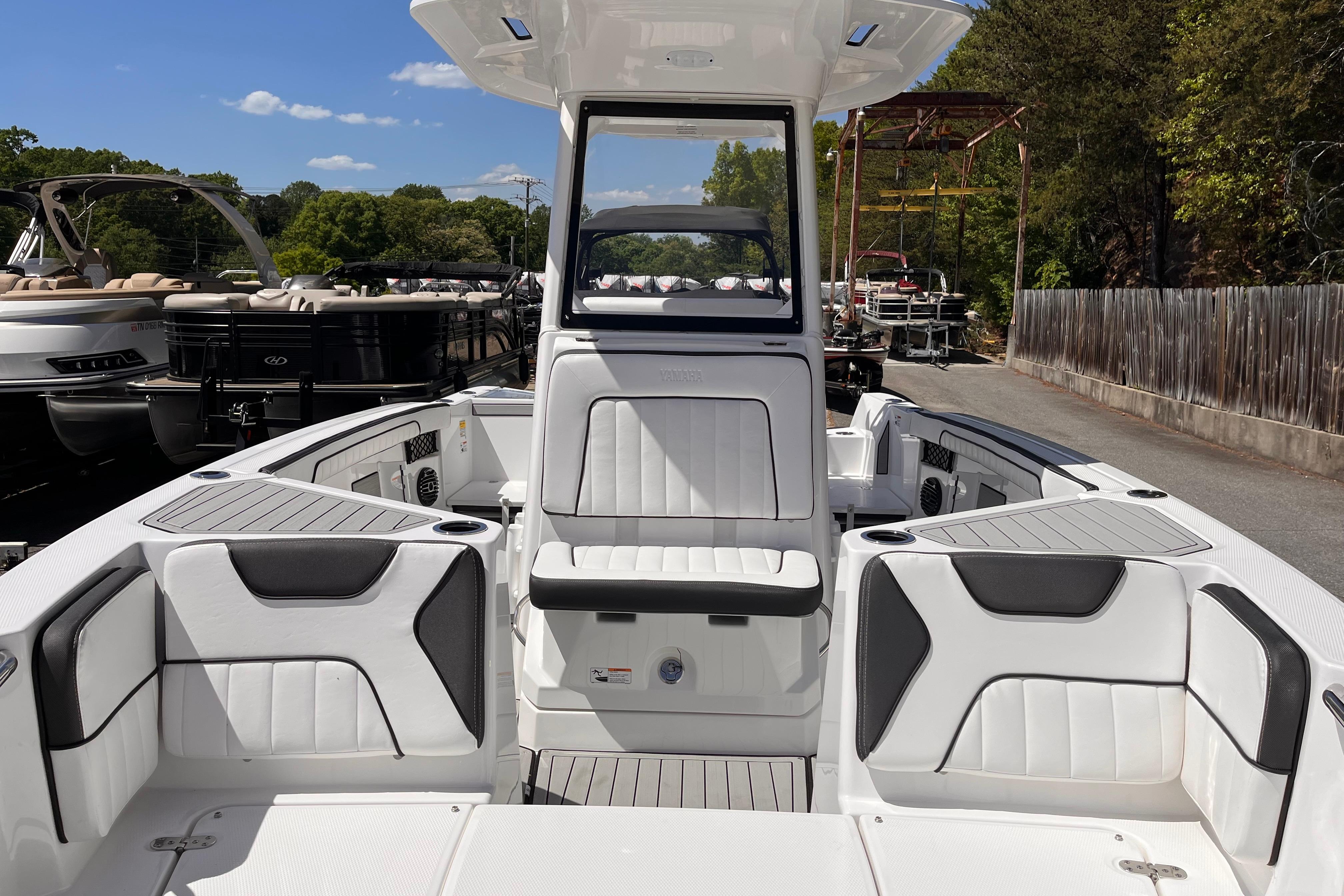 2026 Yamaha Boats 222 FSH Sport E interior with white seating and sleek design.