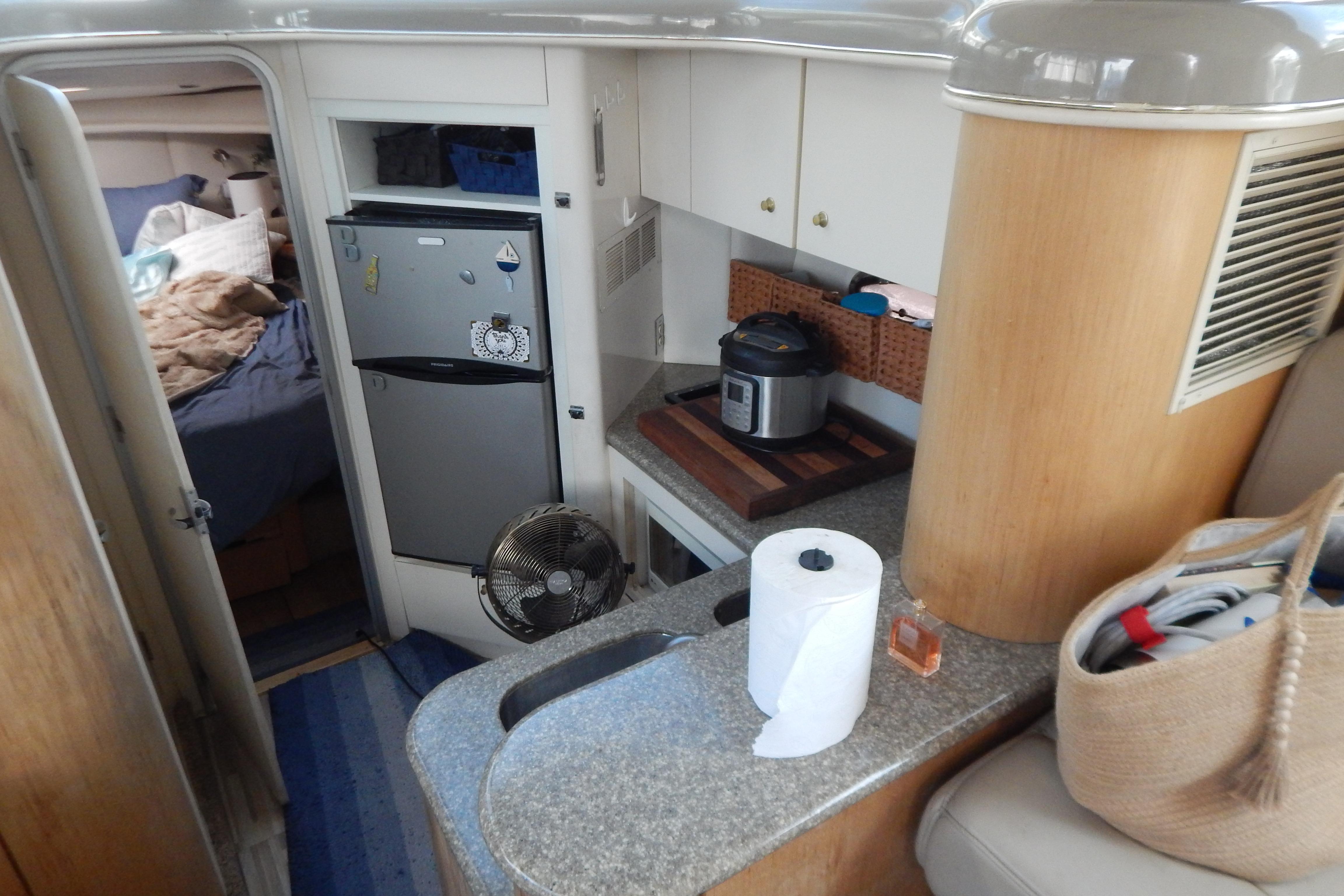 Interior of a 1998 Magnum 4100 SCR yacht with kitchen and sleeping area.