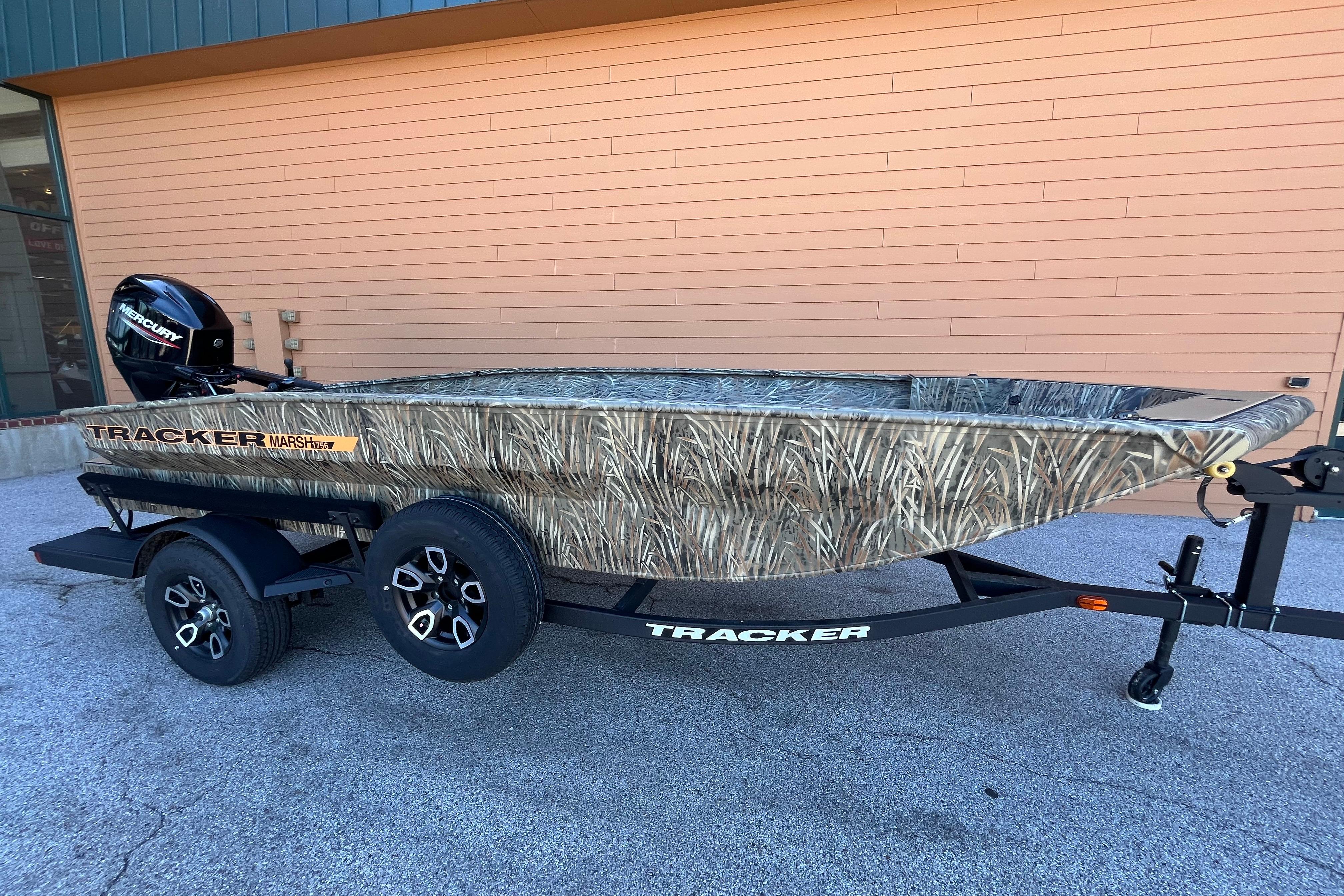 2026 Tracker Grizzly 1756 T Marsh boat with camouflage design on a trailer.