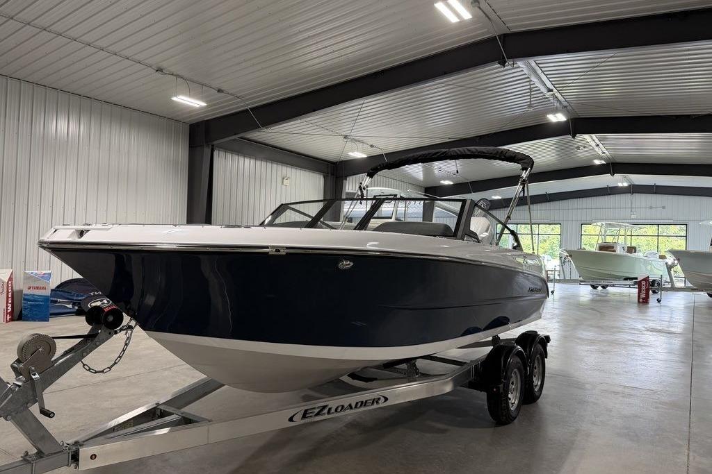 2027 Stingray 20 SBX boat on trailer in indoor showroom.