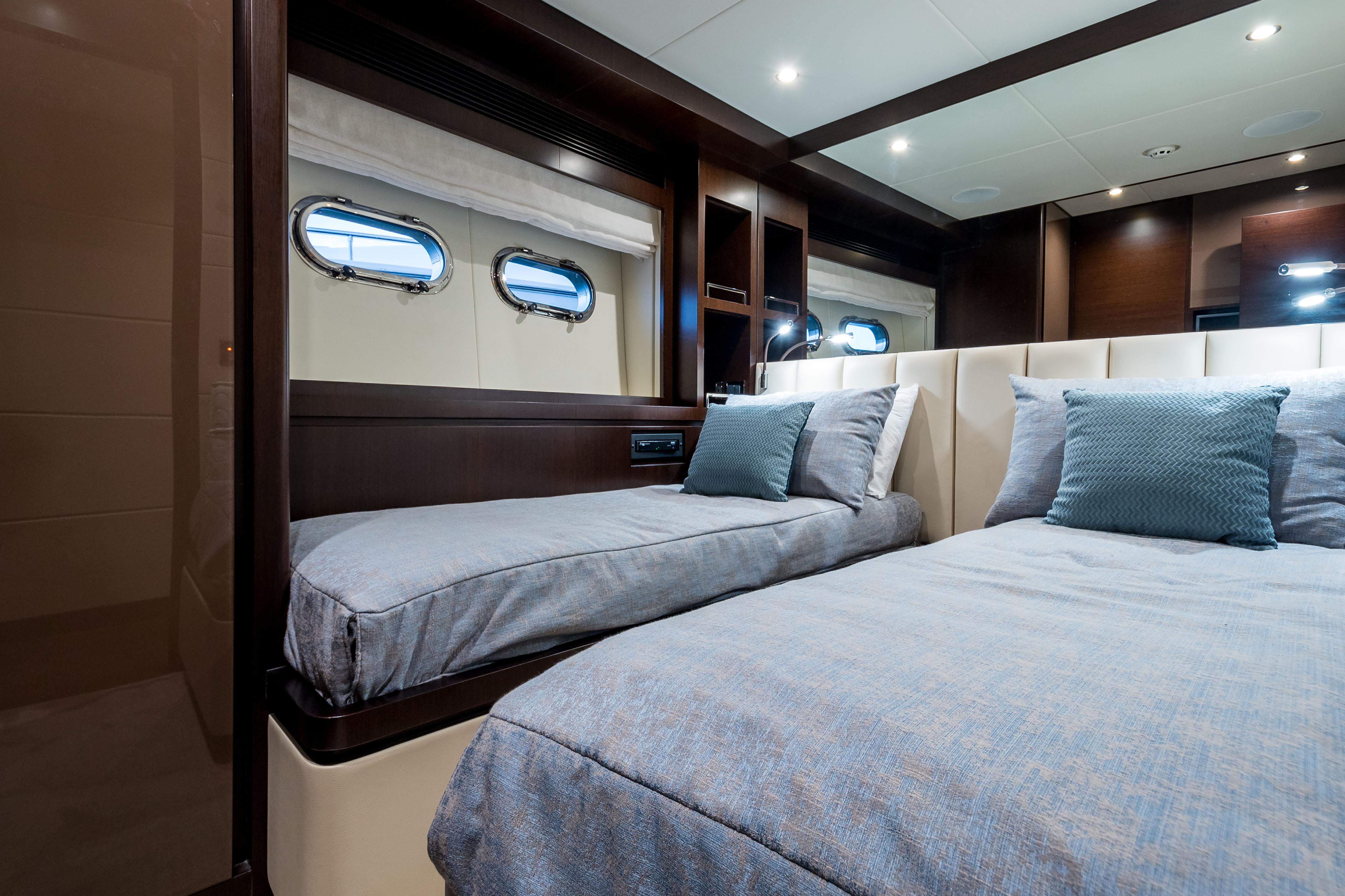 Luxurious cabin interior of 2020 Horizon RP100 yacht with twin beds and elegant decor.