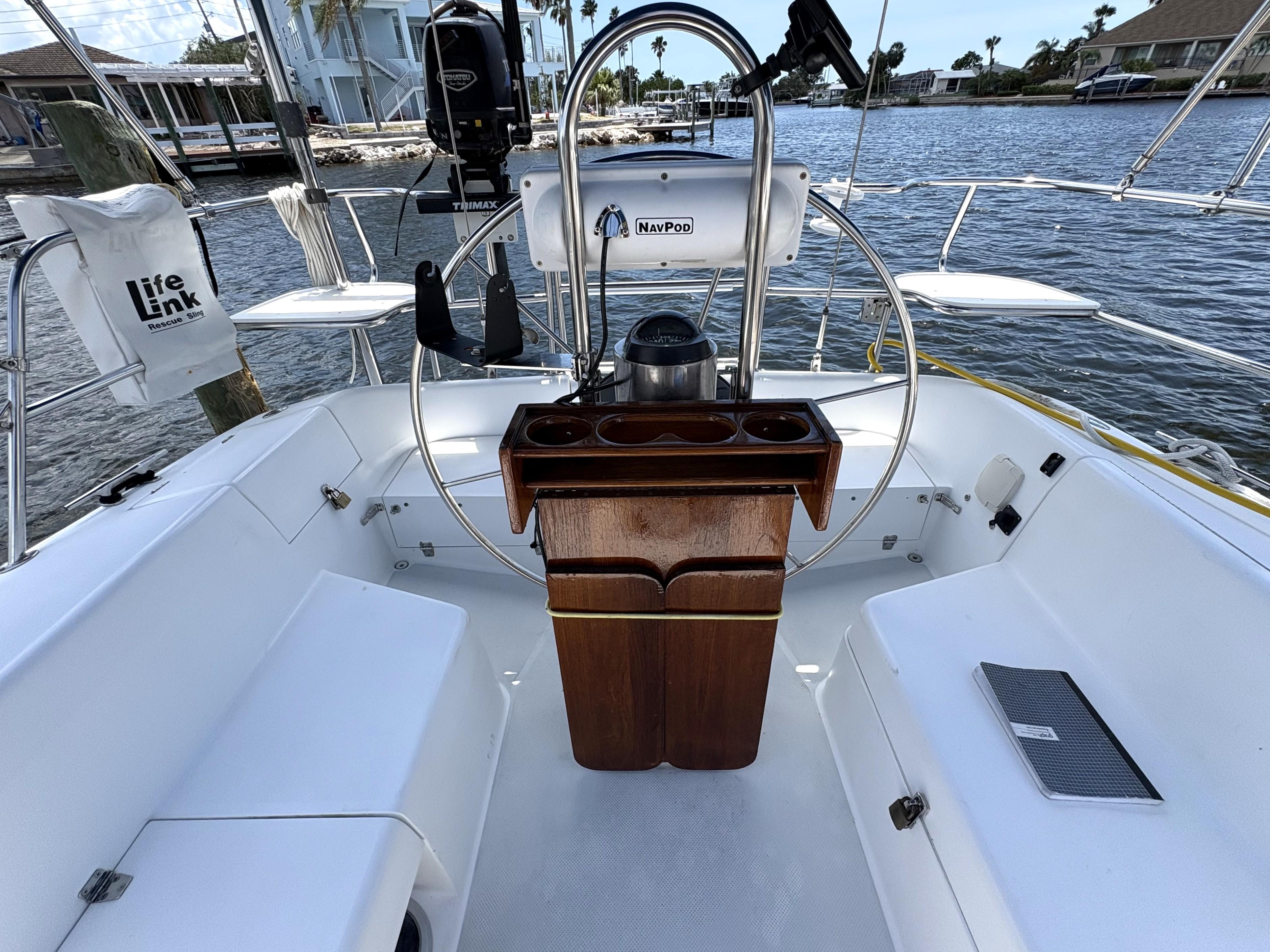 Cockpit of 1998 Catalina 34 MkII sailboat with steering wheel and navigation equipment.