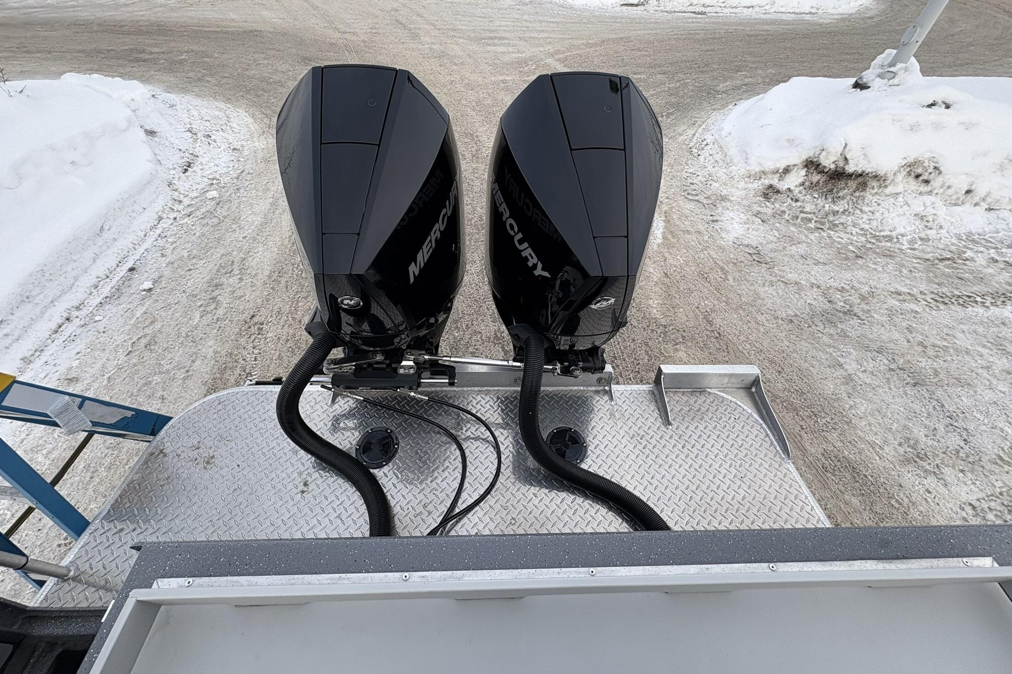 2024 Spartan 26 Maximus Pro XL with dual Mercury outboard motors on snowy terrain.