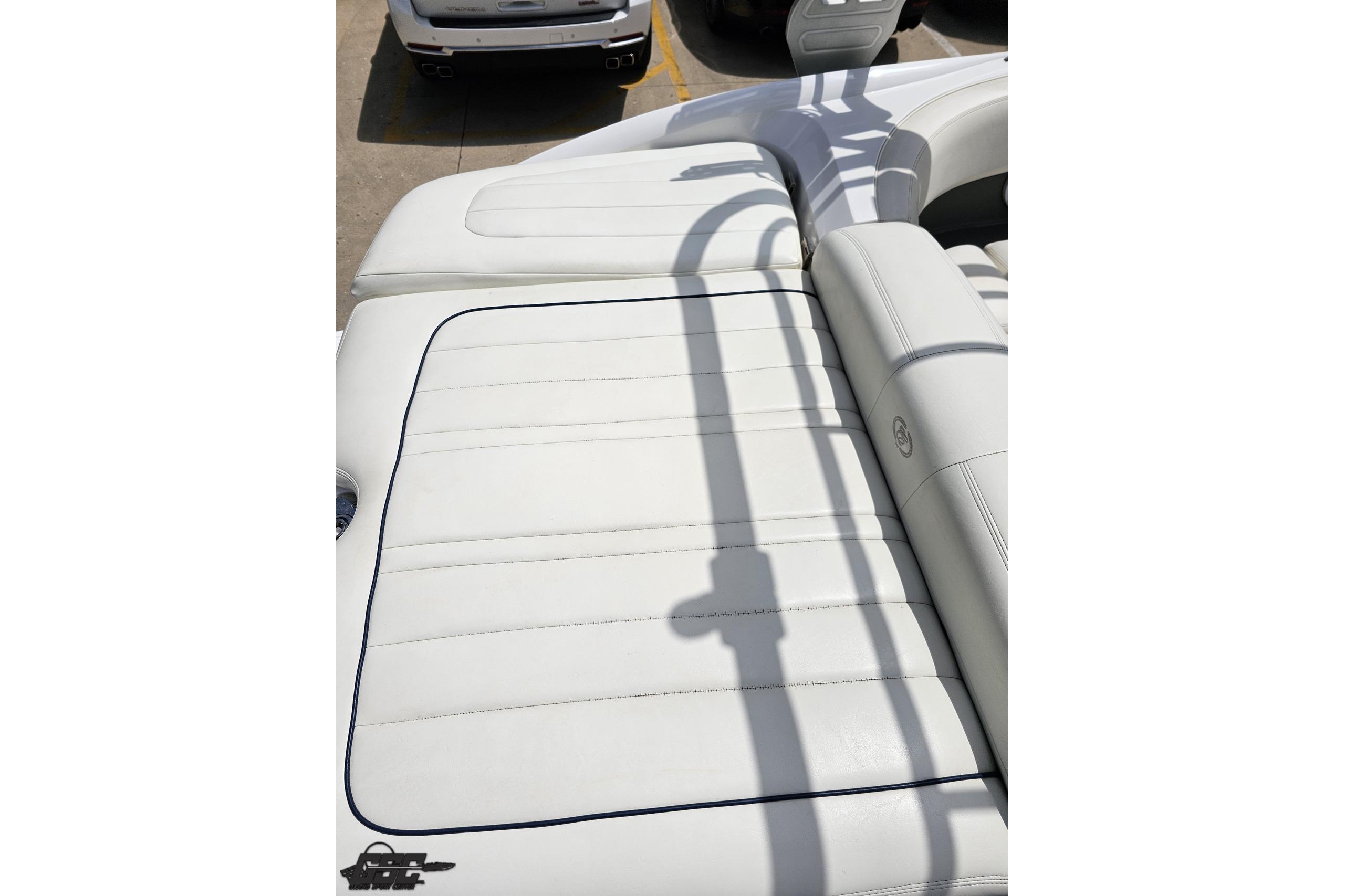2010 Cobalt 232 WSS boat with white leather seating and sleek design.