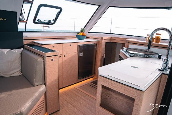 Modern kitchen interior of 2025 Nautitech 40 Open yacht, featuring sleek design and compact appliances.