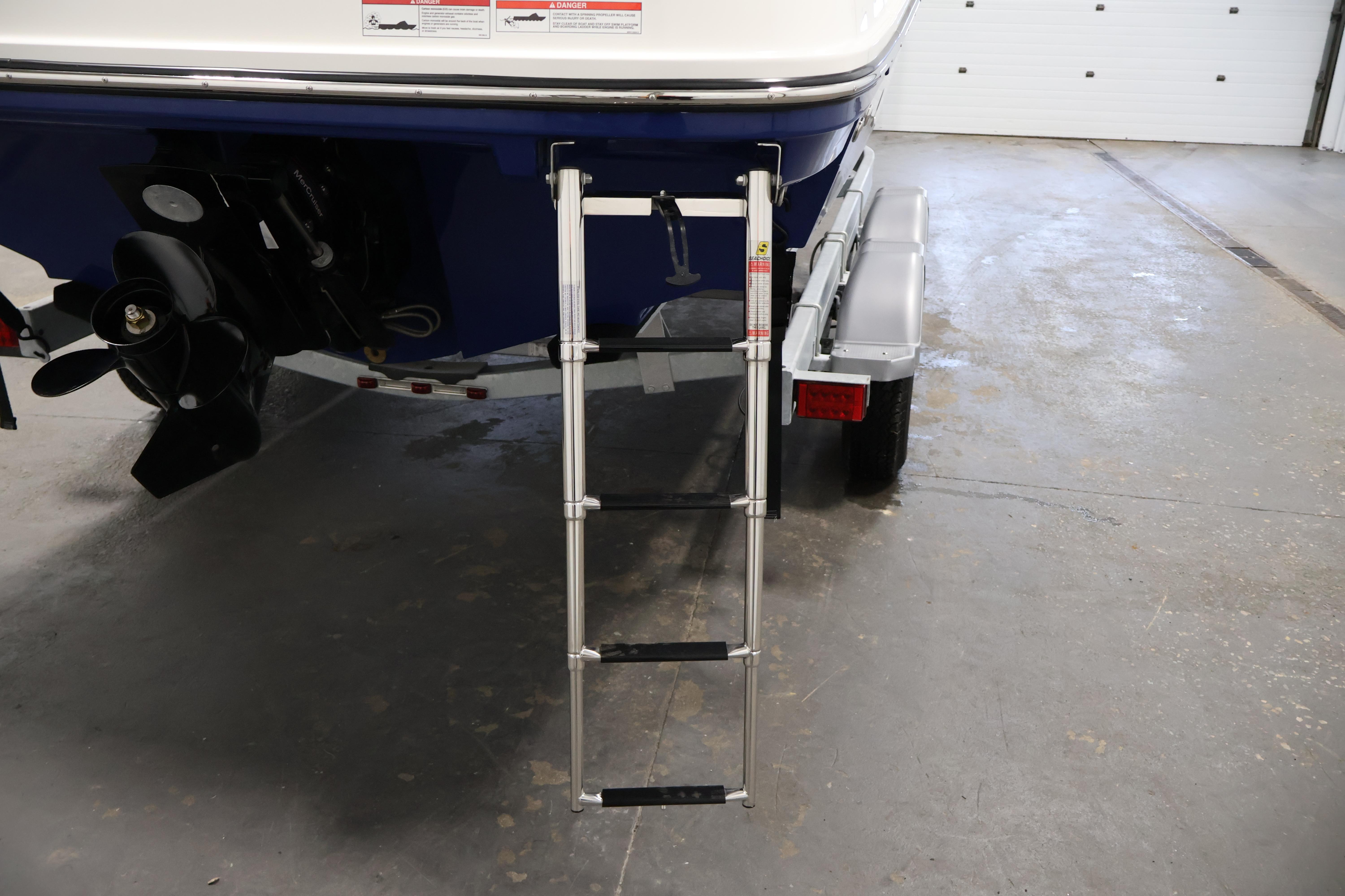 2026 Bayliner VR6 Bowrider I/O with ladder and propeller in a garage setting.