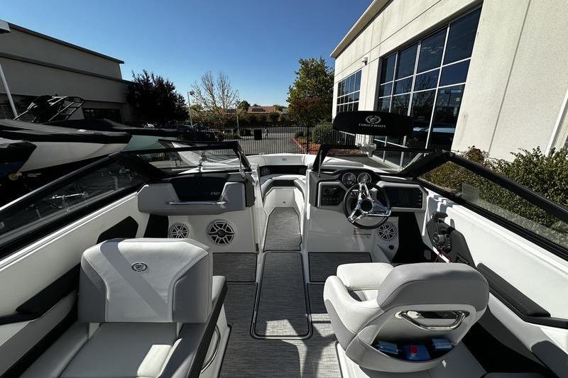 Interior view of a 2025 Cobalt CS23 boat, showcasing sleek seating and modern dashboard.