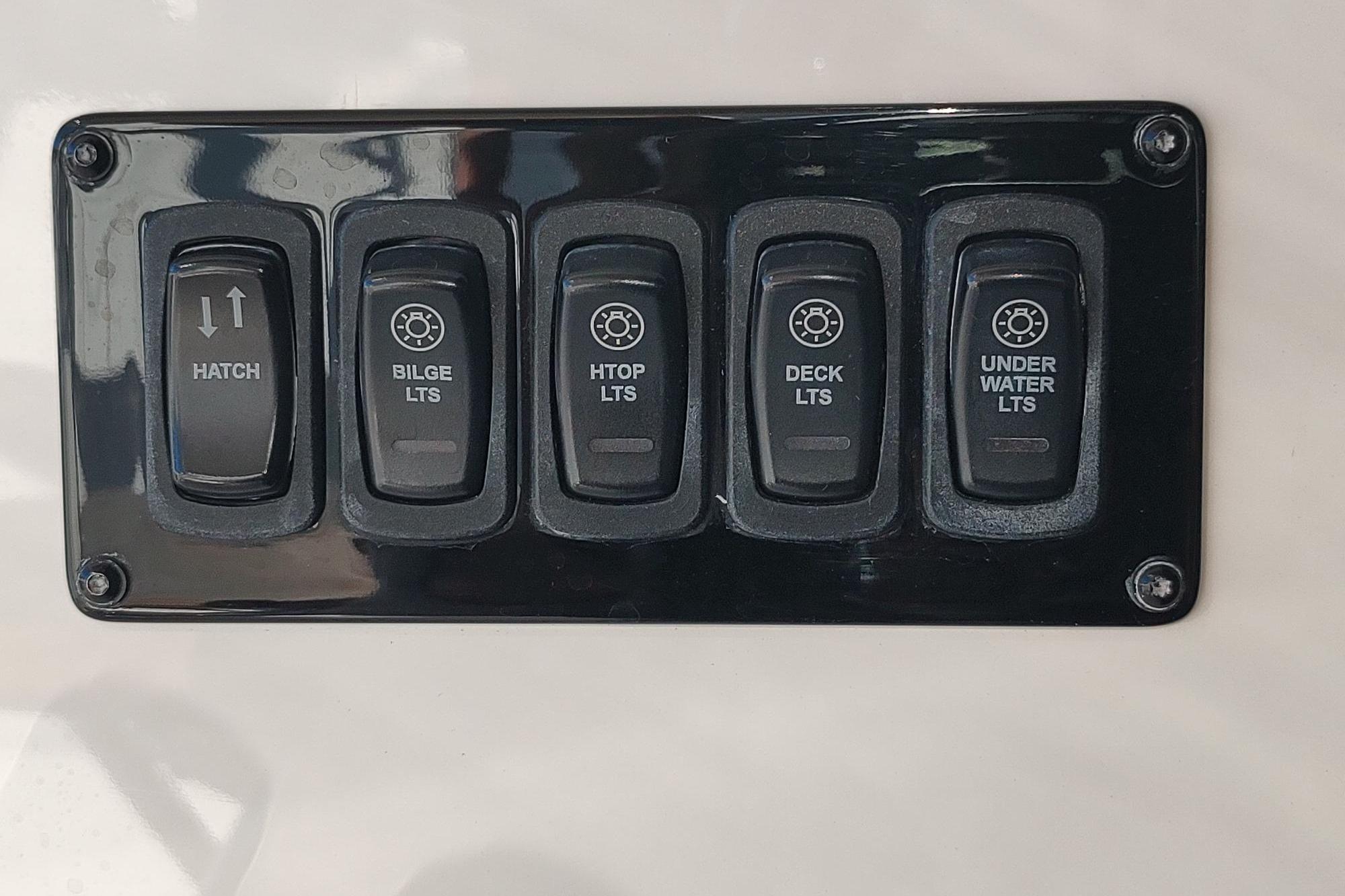 Control panel of a 2021 Regal 42 Fly boat with switches for hatch and lights.