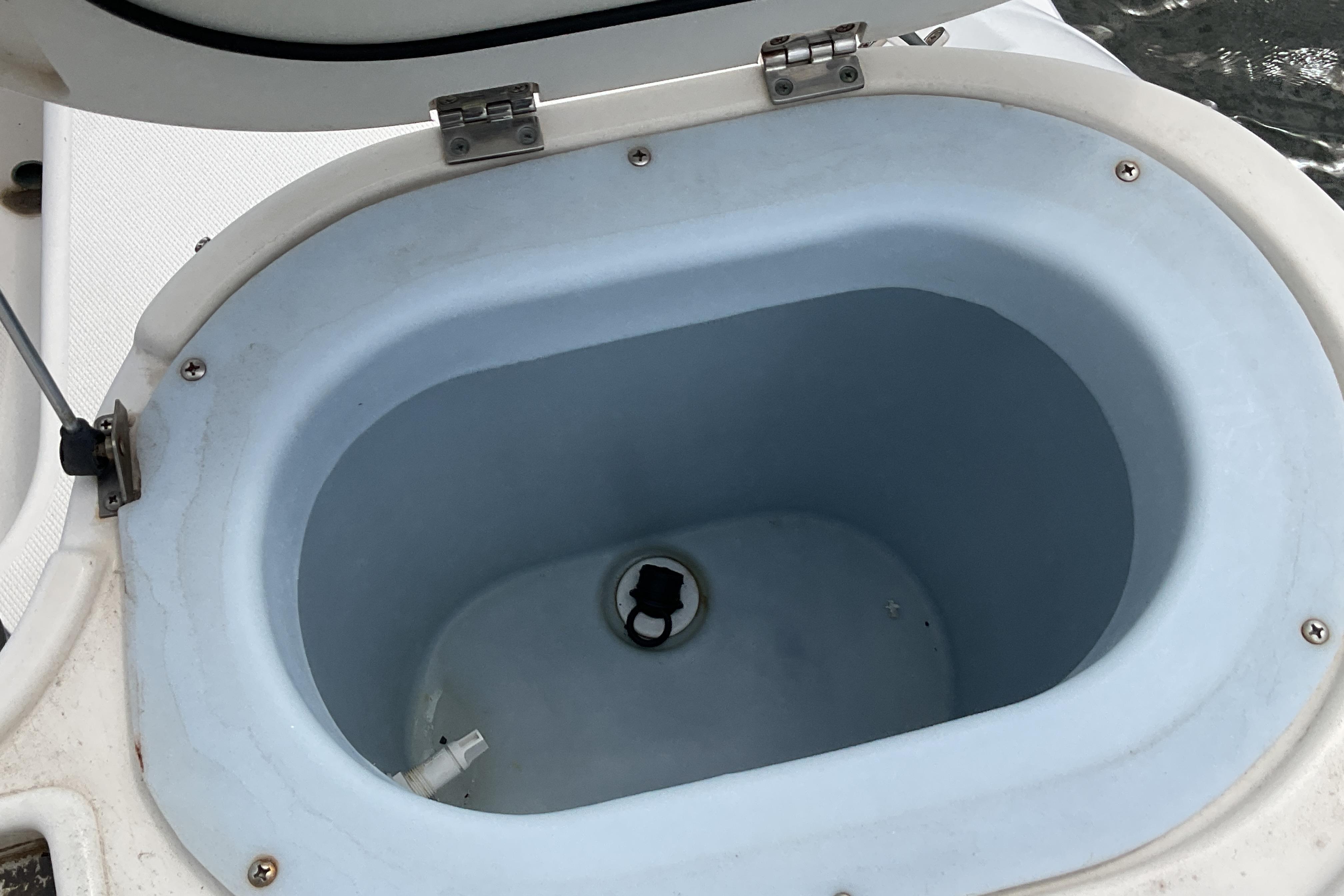 Livewell compartment on a 2012 Wellcraft 232 Coastal boat, open and empty.