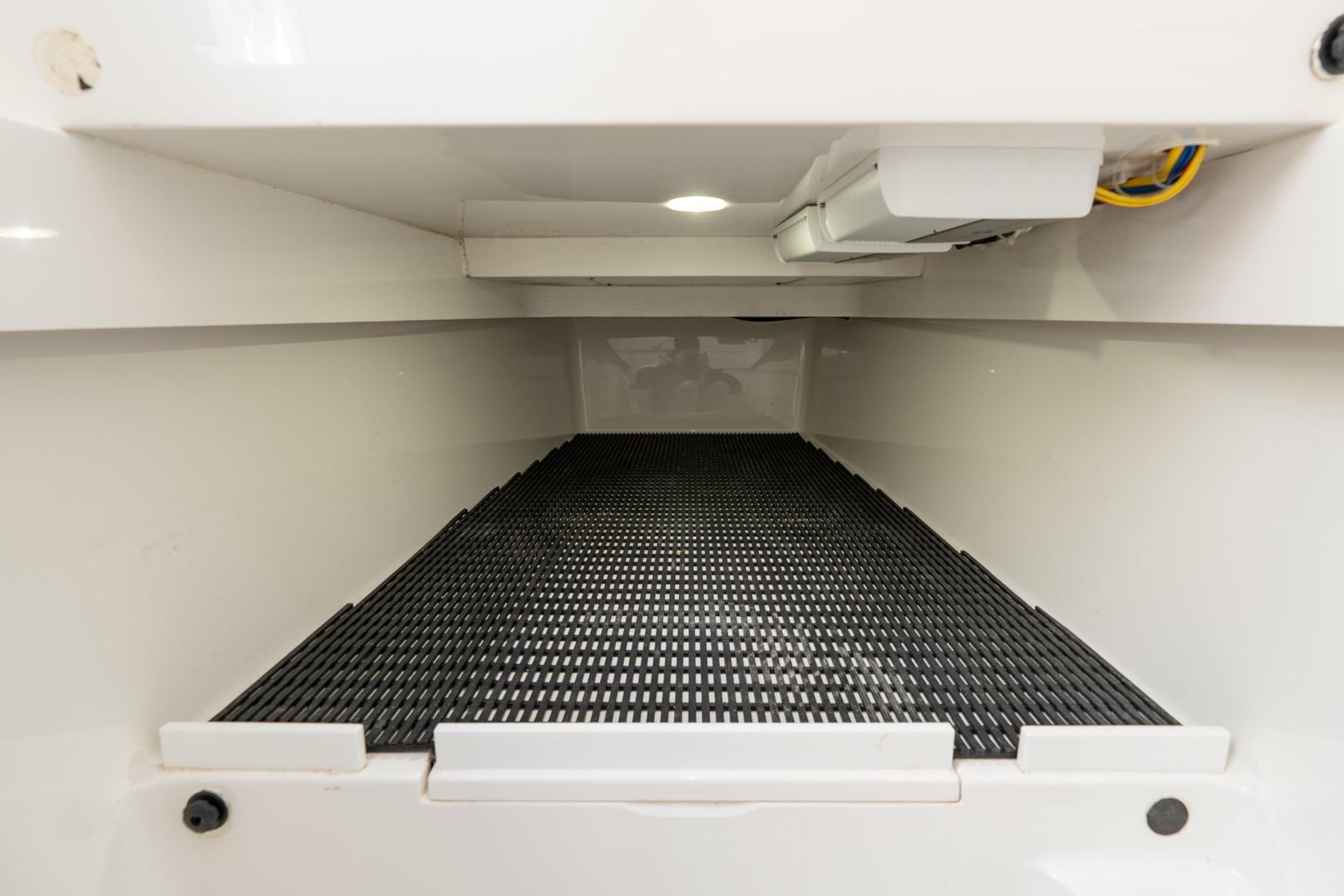 Interior storage compartment of 2022 Valhalla Boatworks V-37, featuring a non-slip surface.