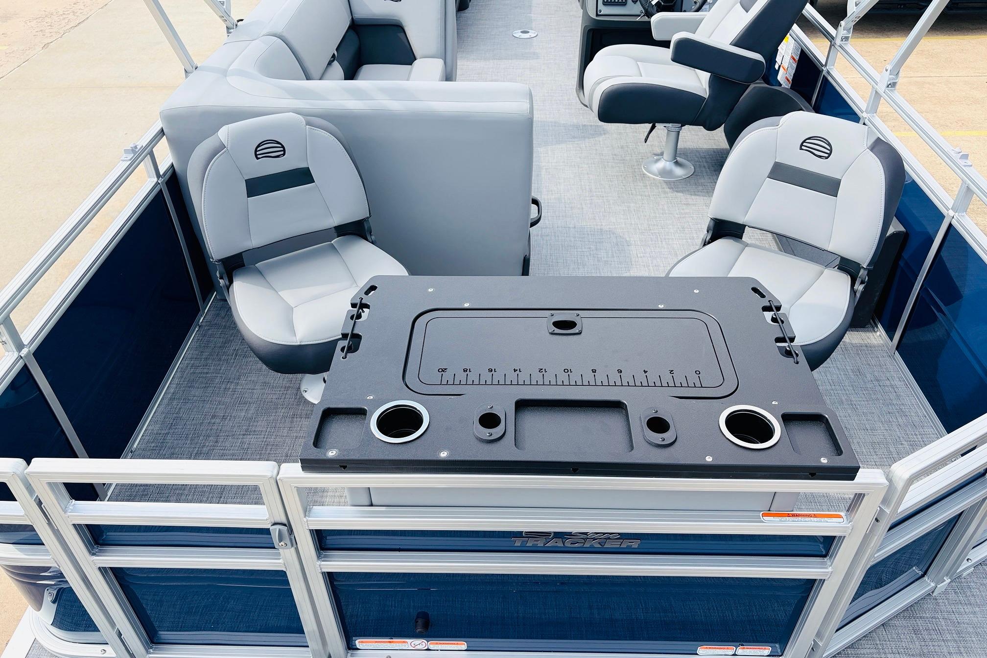 2026 Sun Tracker SportFish 22 DLX pontoon boat interior with seating and fishing station.