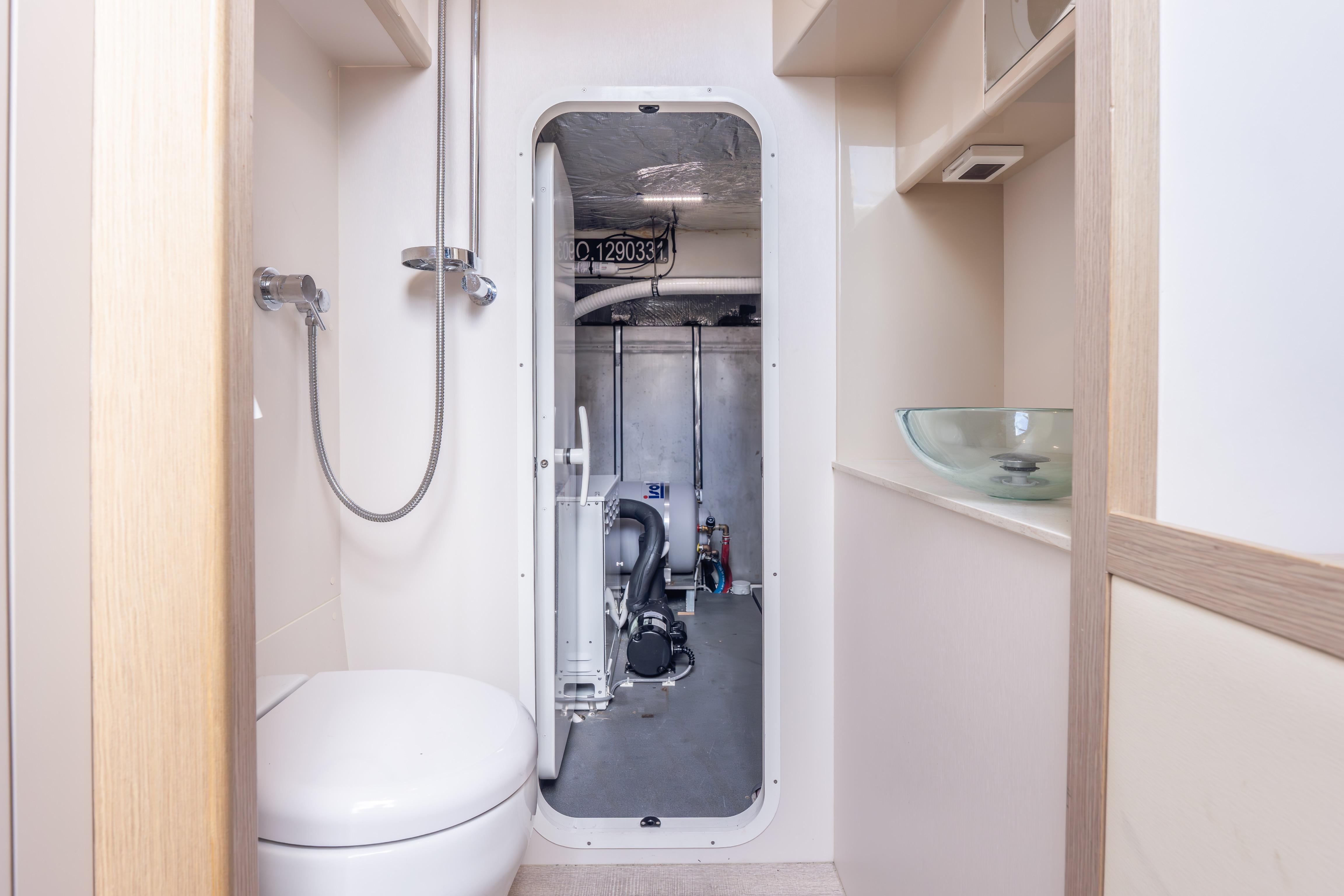 Bathroom interior of 2019 Absolute 58 FLY yacht with modern fixtures and glass sink.