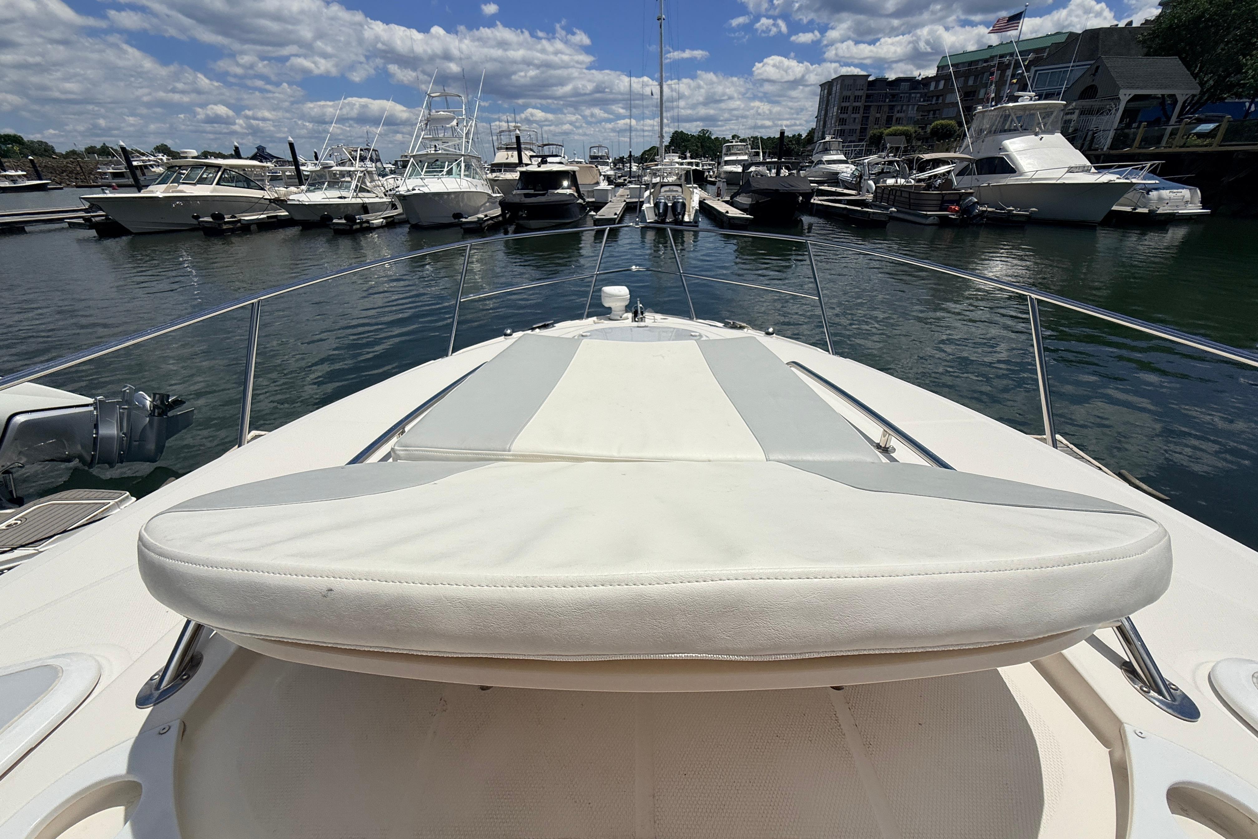 2011 Monterey 320 Sport Yacht docked at marina, surrounded by boats under a blue sky.
