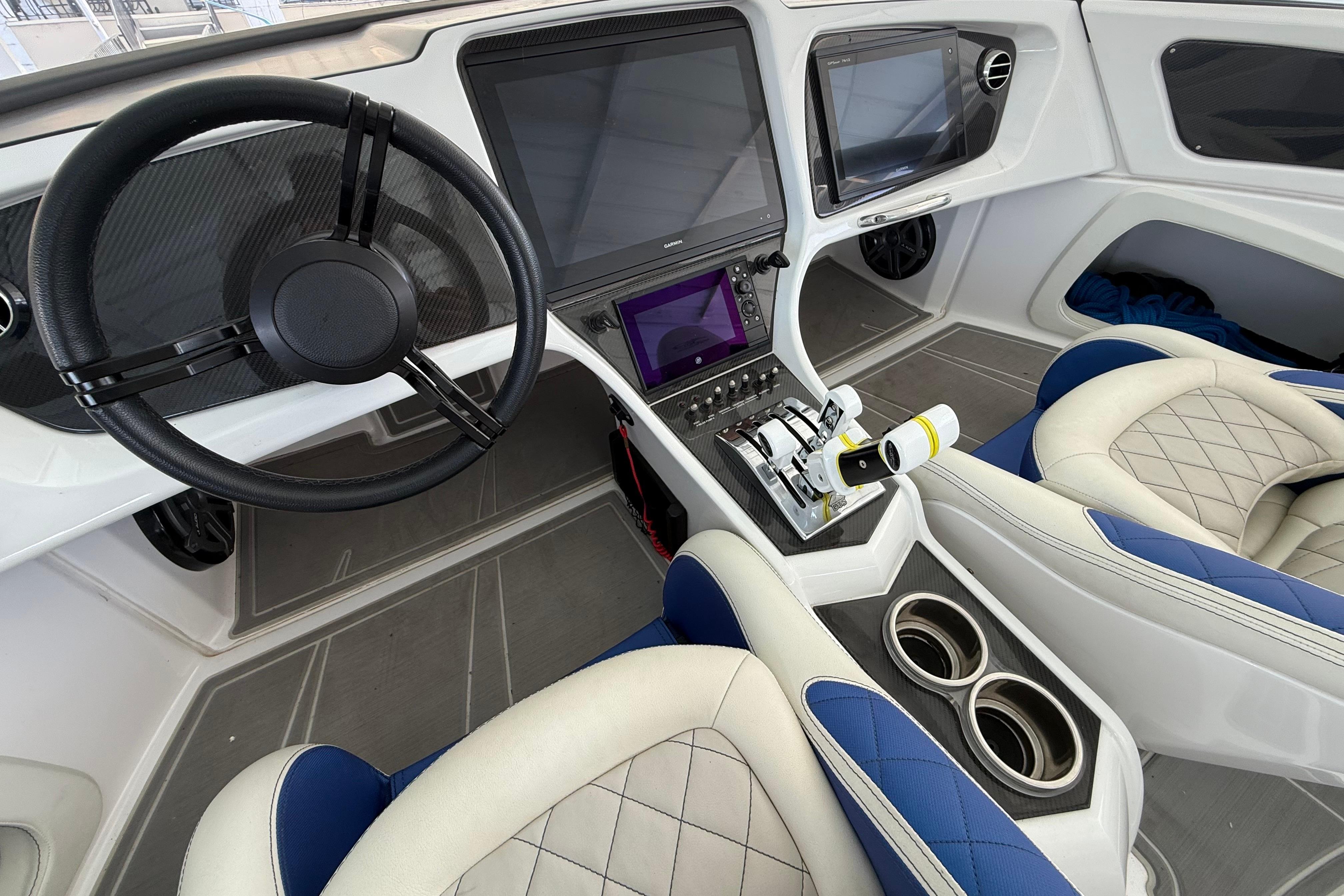 Interior of a 2018 MTI 340X boat featuring modern steering and control panels.