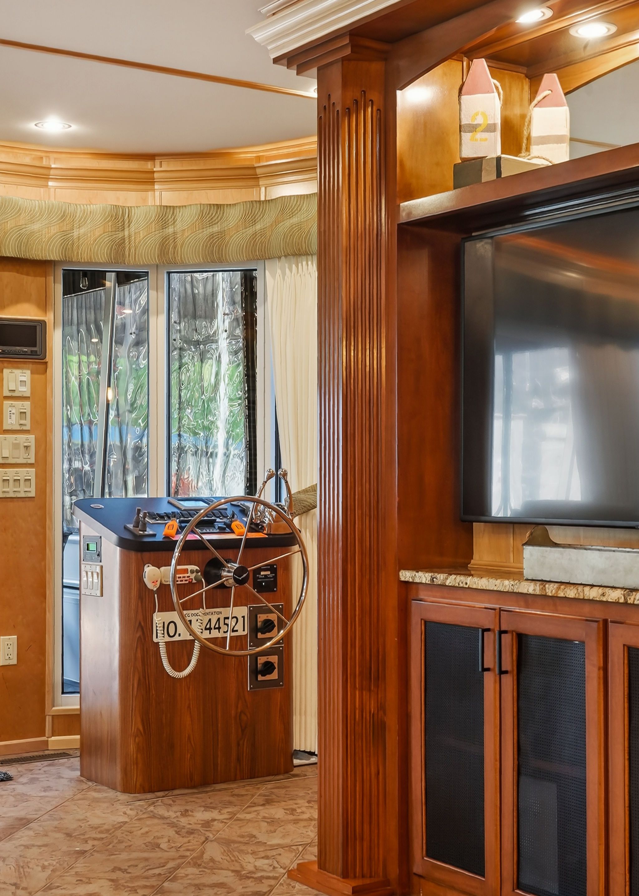 Interior of a 2010 Houseboat Throughbred with steering wheel and wood paneling.