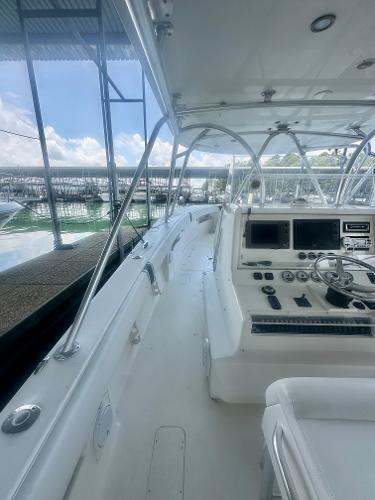2008 SeaVee 390B boat interior with helm, controls, and seating under a canopy.