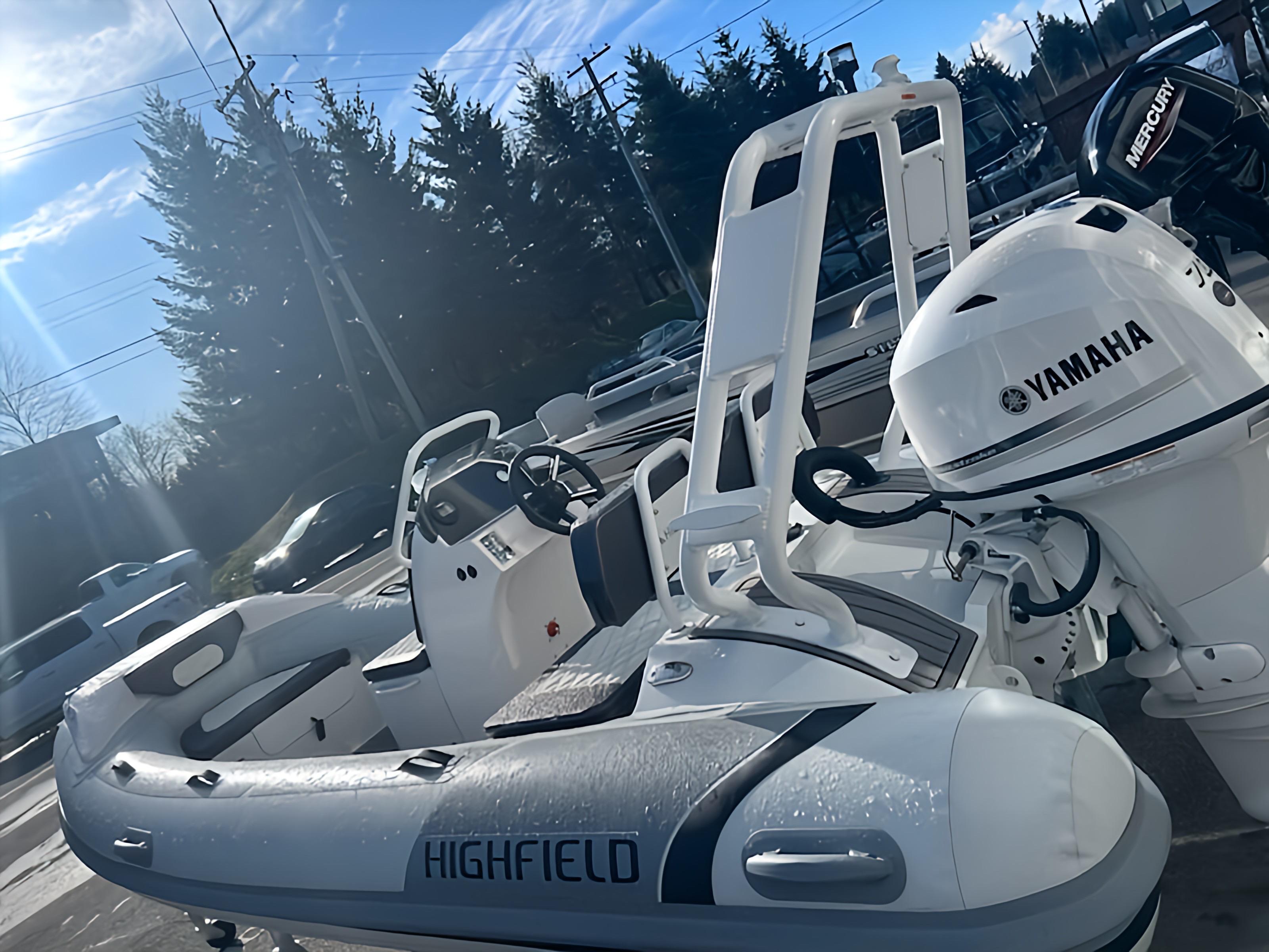 2023 Highfield Sport 420 boat with Yamaha engine, parked outdoors under clear sky.