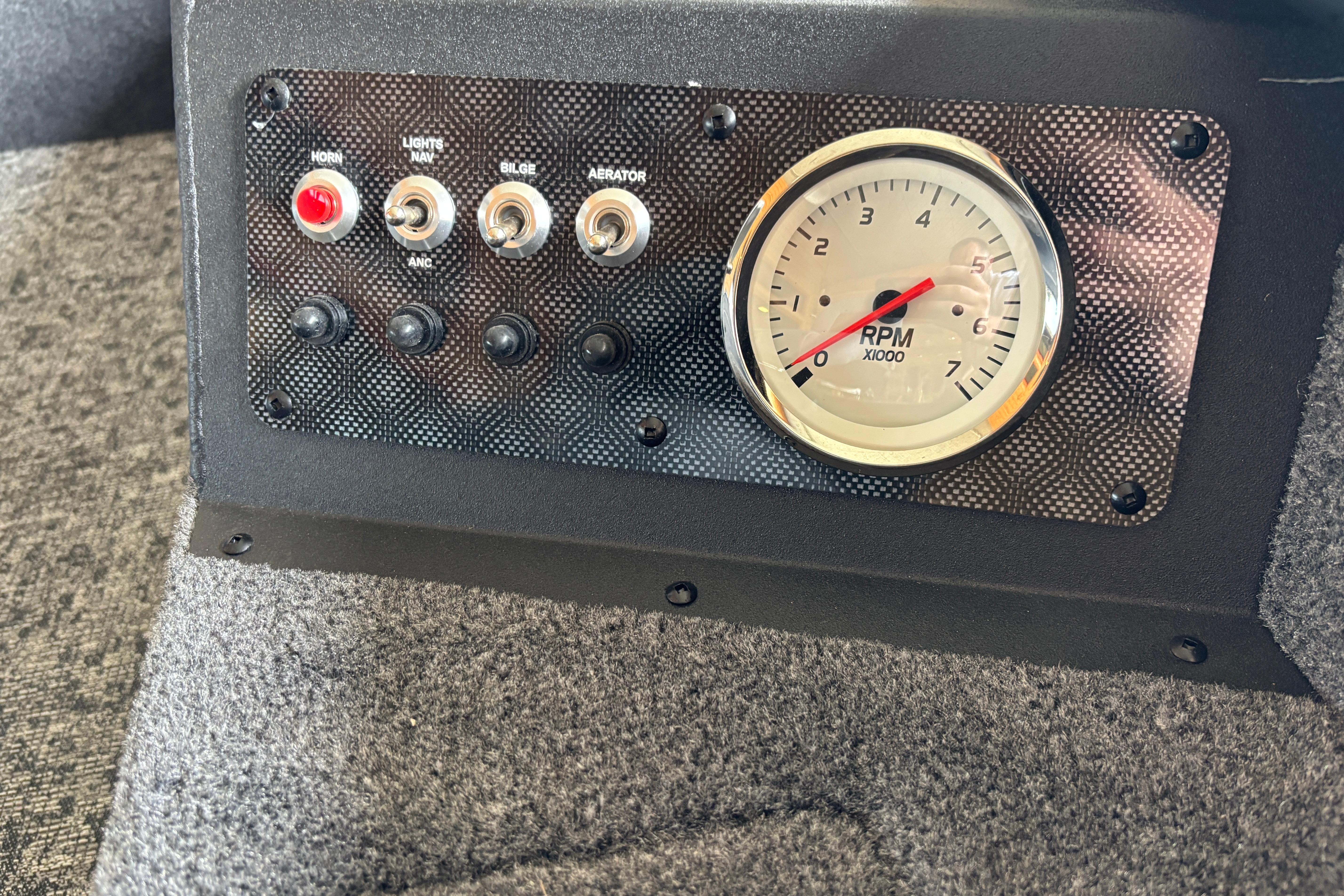 Control panel of 2026 Tracker Super Guide V-16 T with RPM gauge and switches.