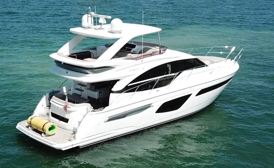 Luxurious 2018 Princess F55 yacht cruising on clear blue waters.