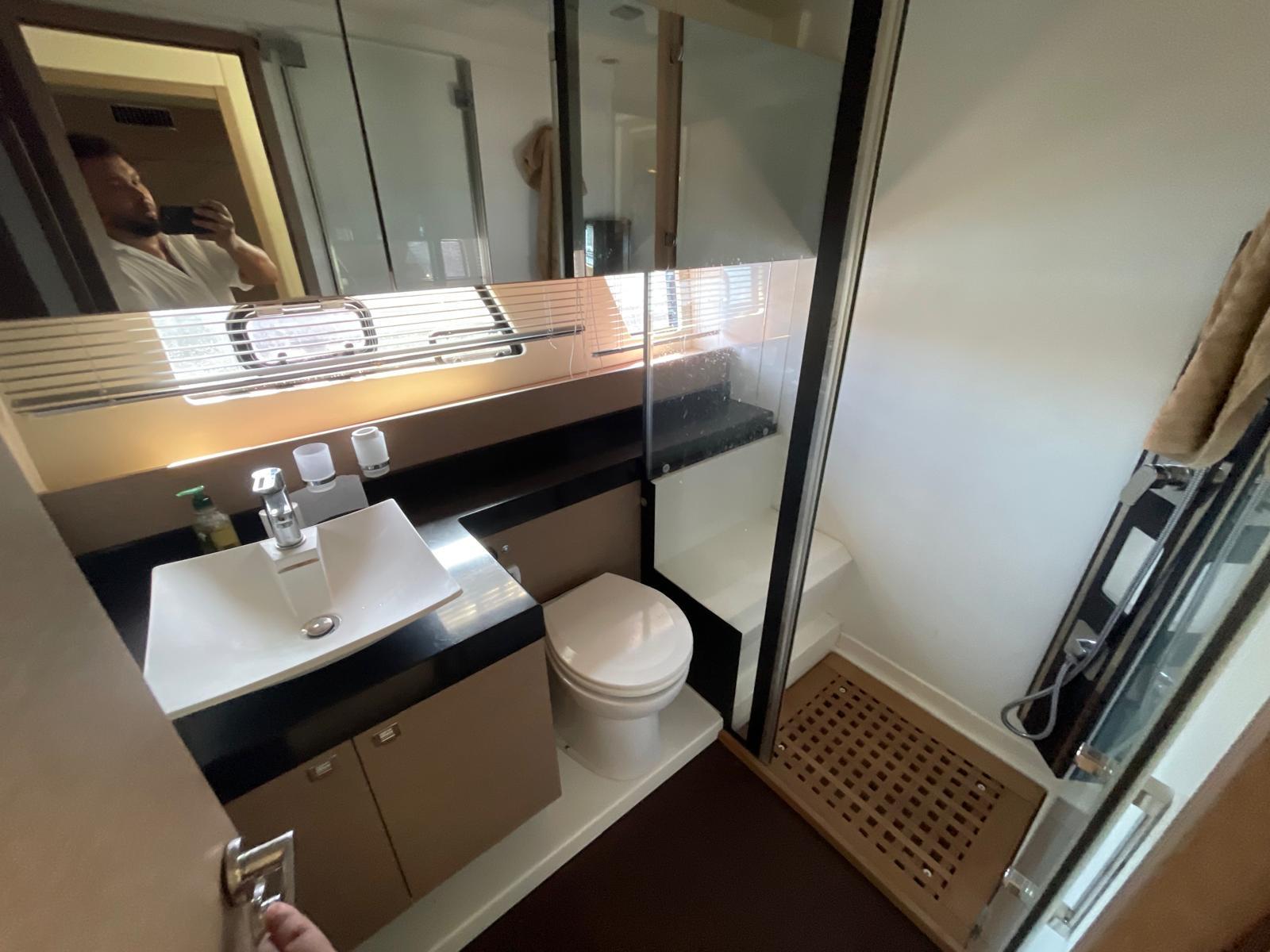 Luxurious bathroom in 2018 Prestige 560 yacht with modern fixtures and shower.