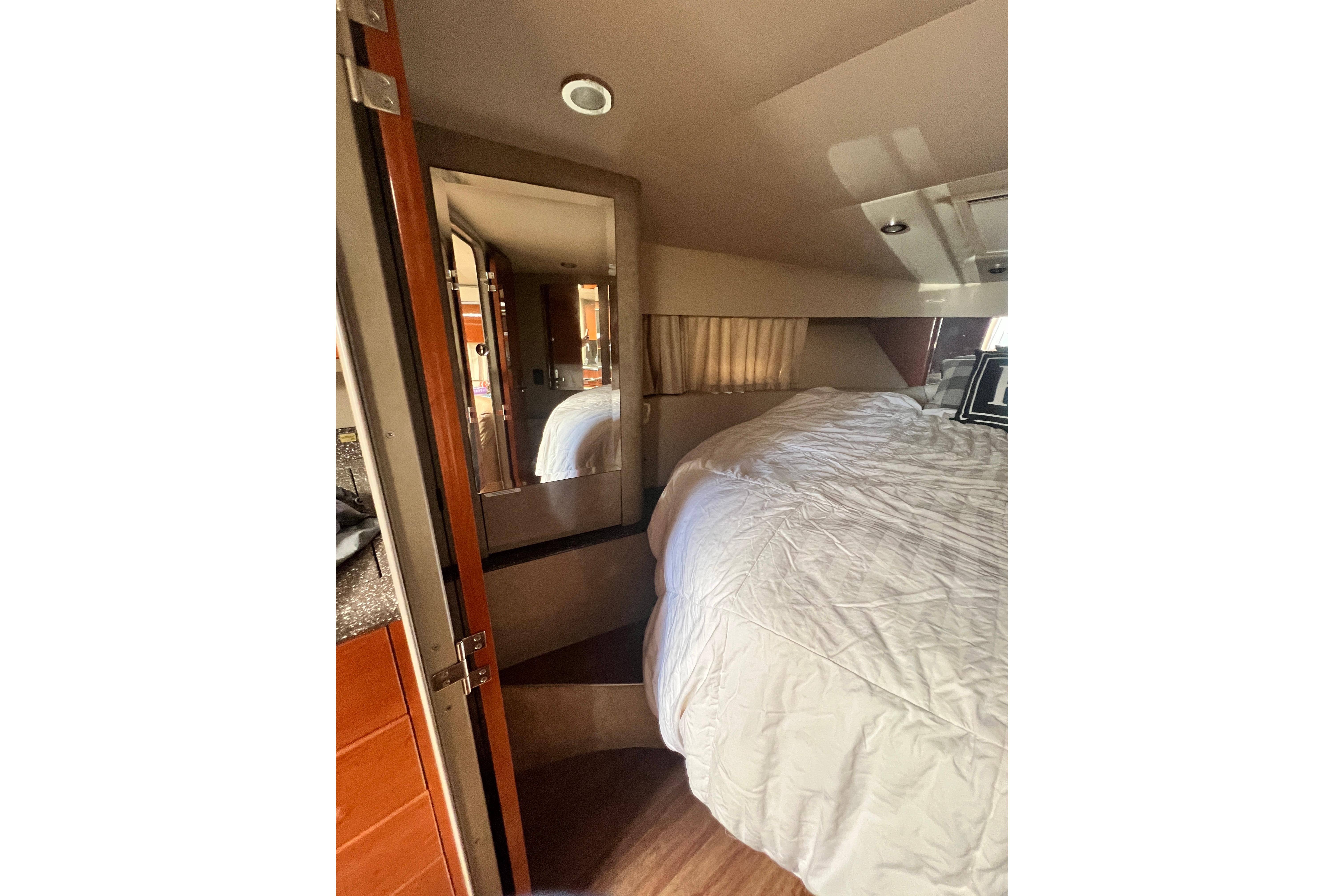 Interior of 2006 Formula 40 Performance Cruiser with cozy bed and wooden accents.
