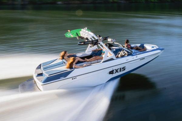 Manufacturer Provided Image: 2022 Axis A22 speedboat cruising on a lake with passengers.