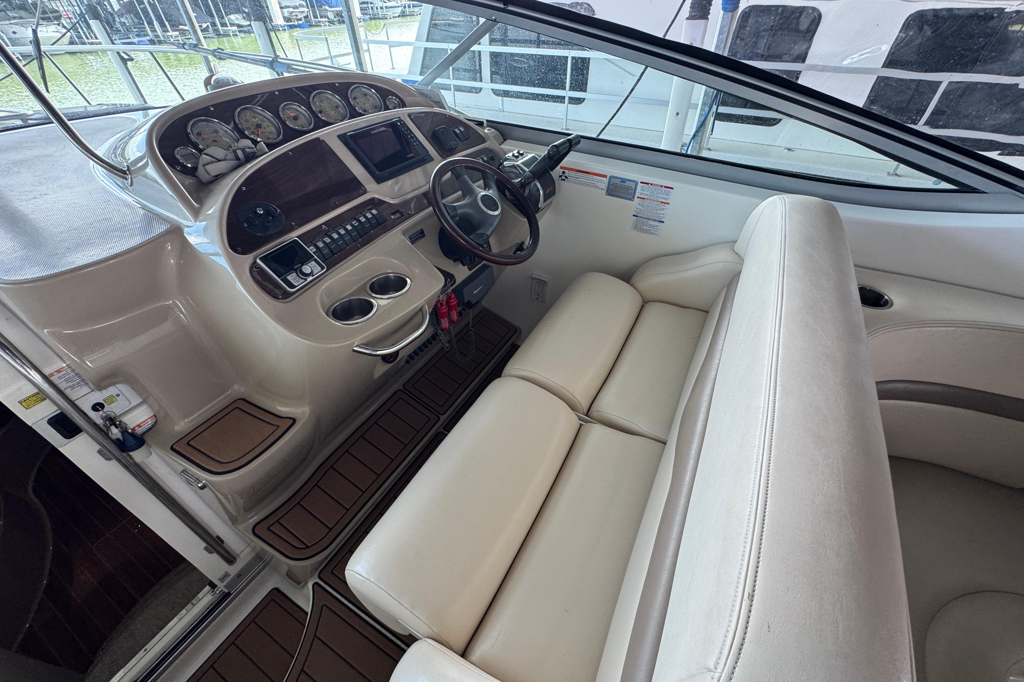 2006 Chaparral 330 Signature boat cockpit with steering wheel and instrument panel.