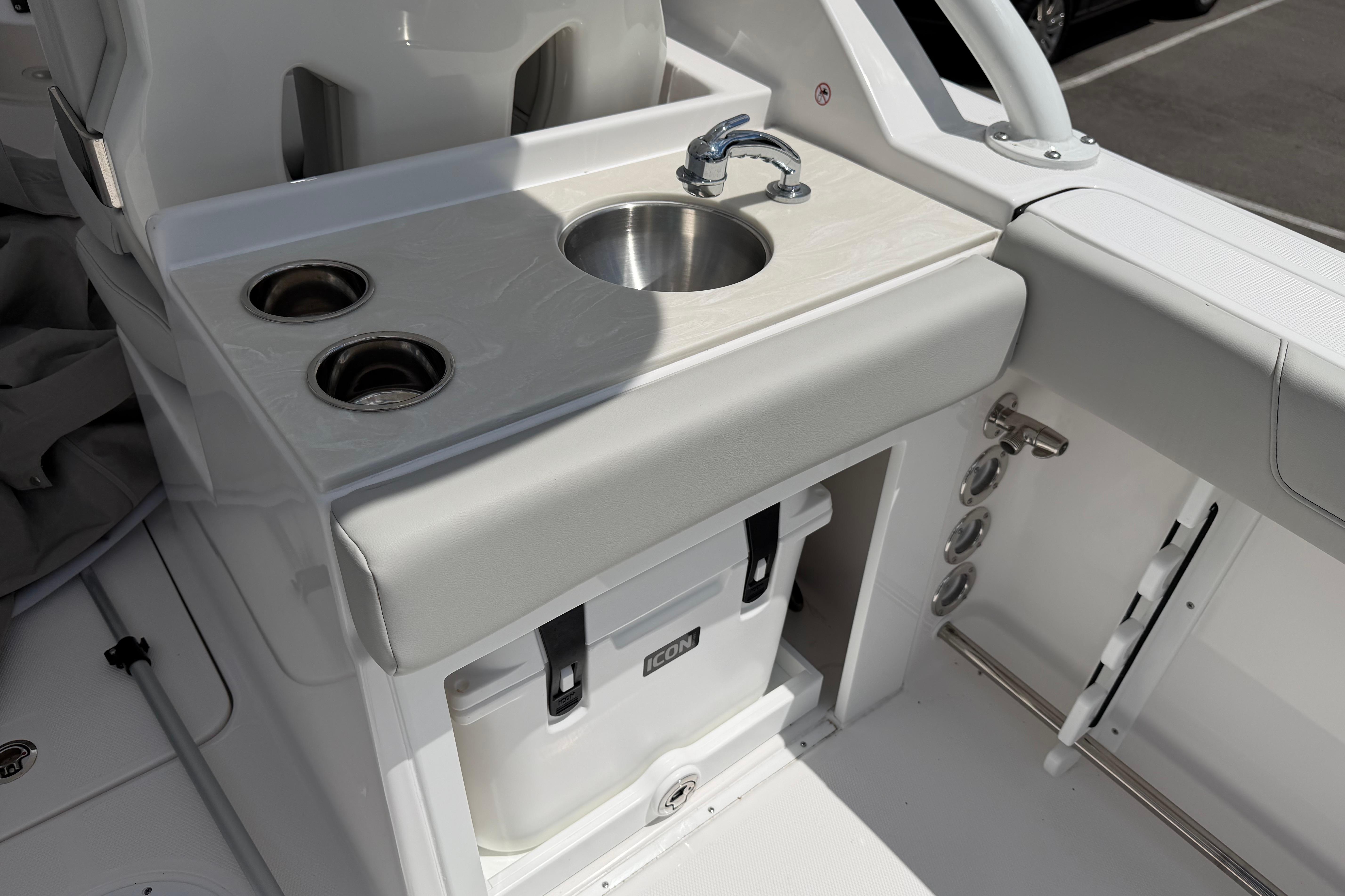 2026 Edgewater 248CX Crossover boat interior with sink and cup holders.