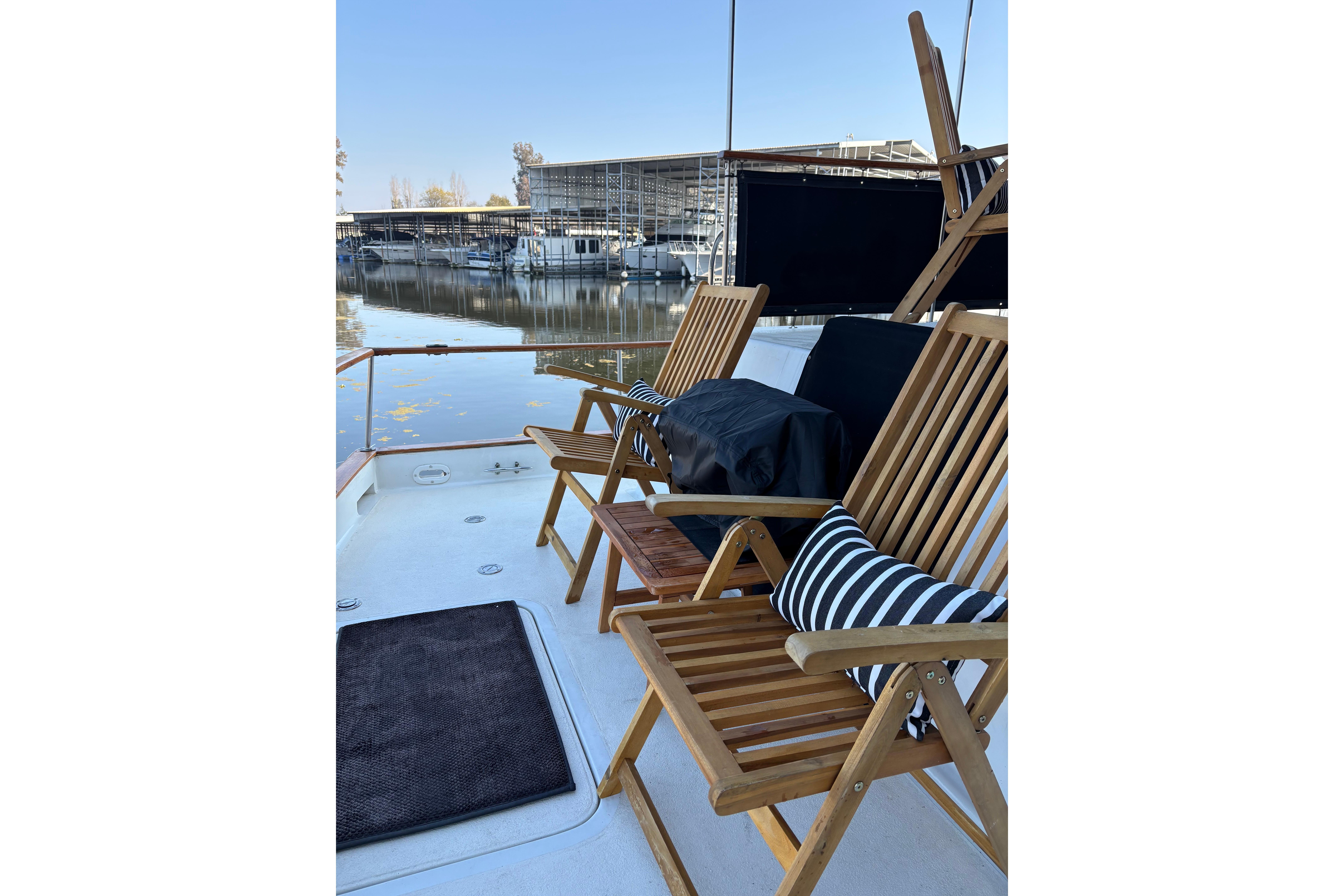 1978 Californian 42 LRC yacht deck with wooden chairs and marina view.