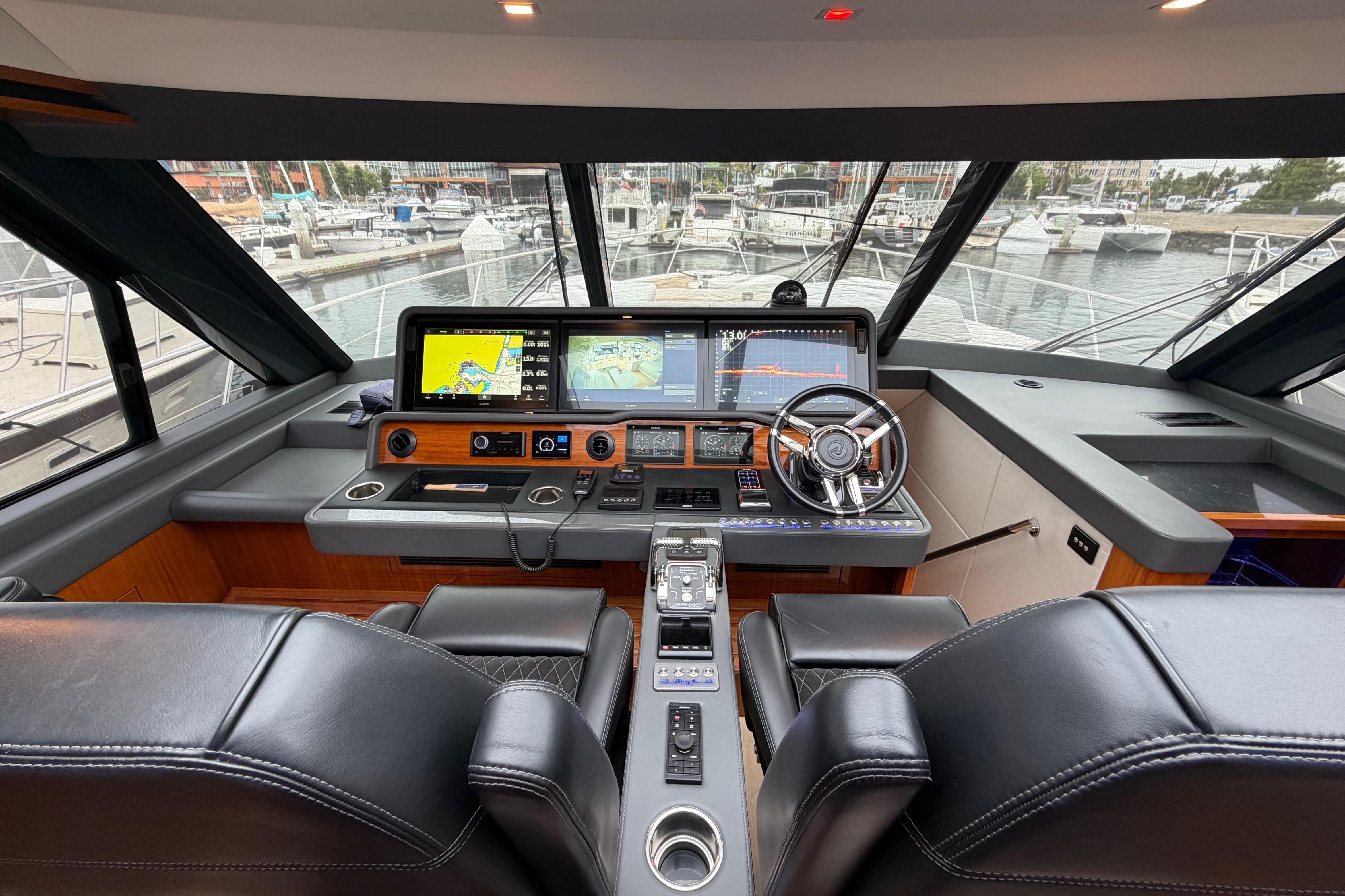 Interior cockpit of 2023 Riviera 645 SUV yacht with advanced navigation systems.