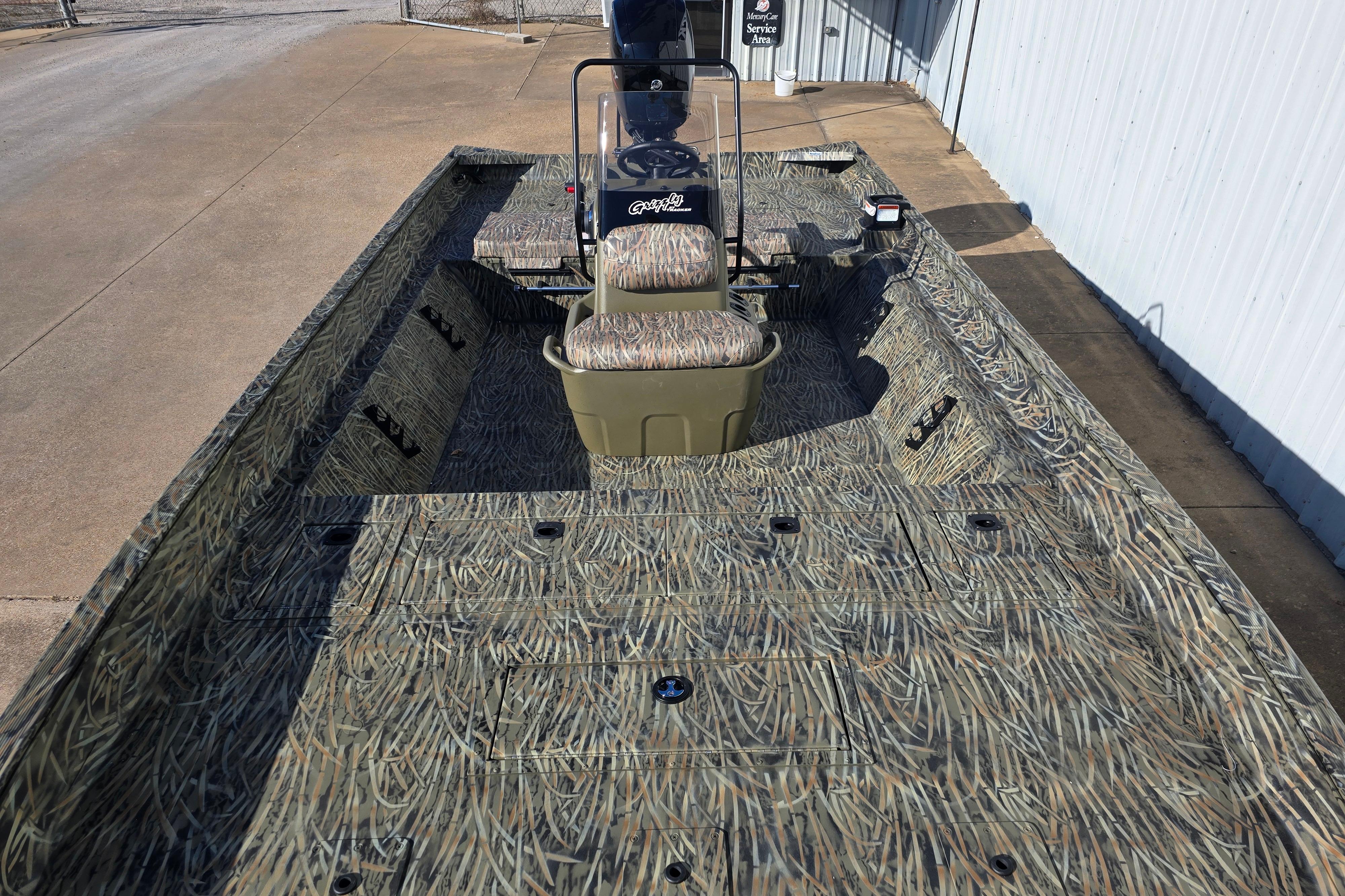2026 Tracker Grizzly 2072 CC boat with camouflage design, parked outdoors.