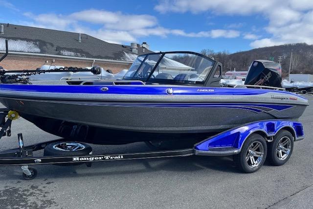 2026 Ranger 1880MS boat on trailer, blue and black design, parked outdoors.