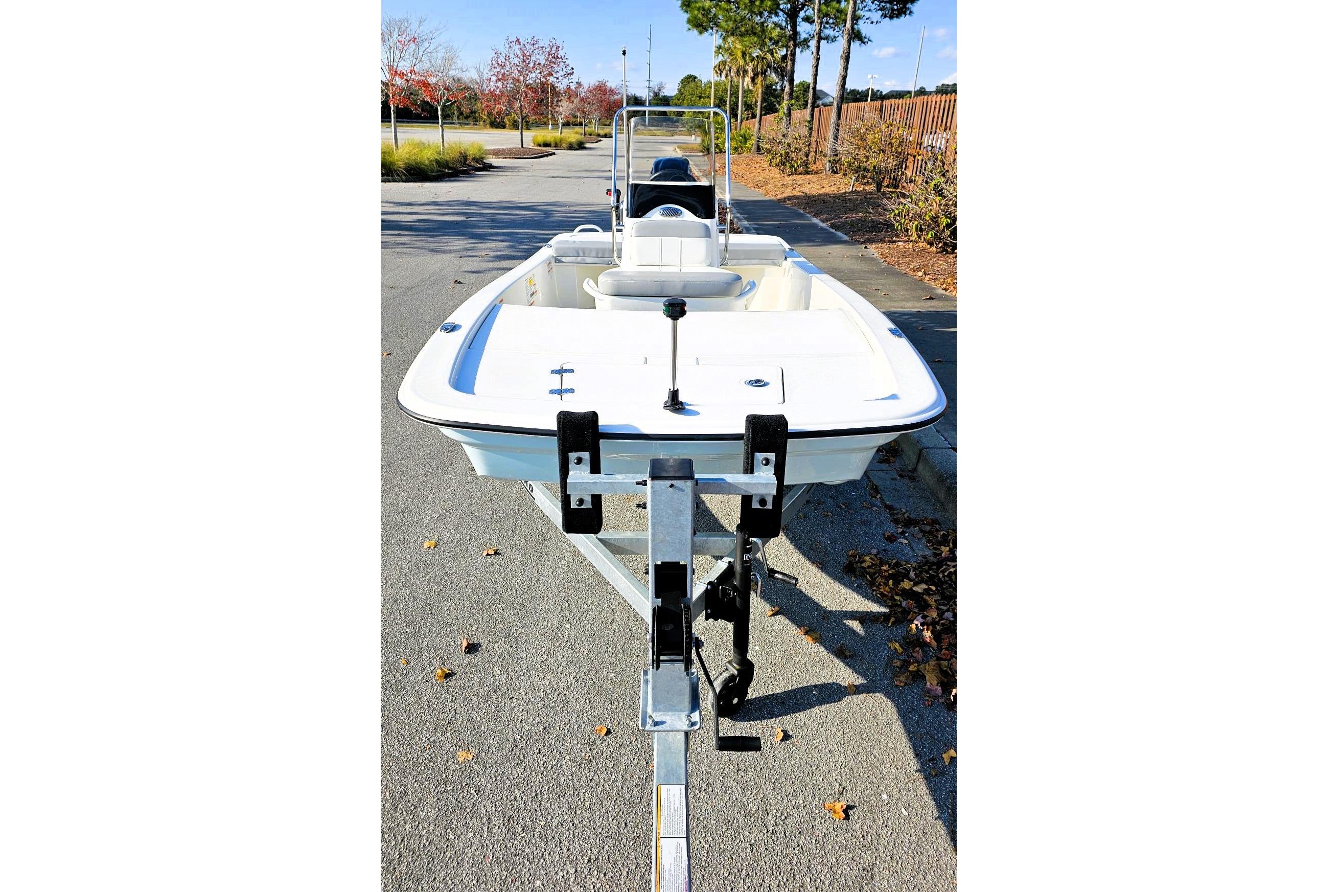 2026 Mako Pro Skiff 13 CC boat on trailer, parked on a sunny street.