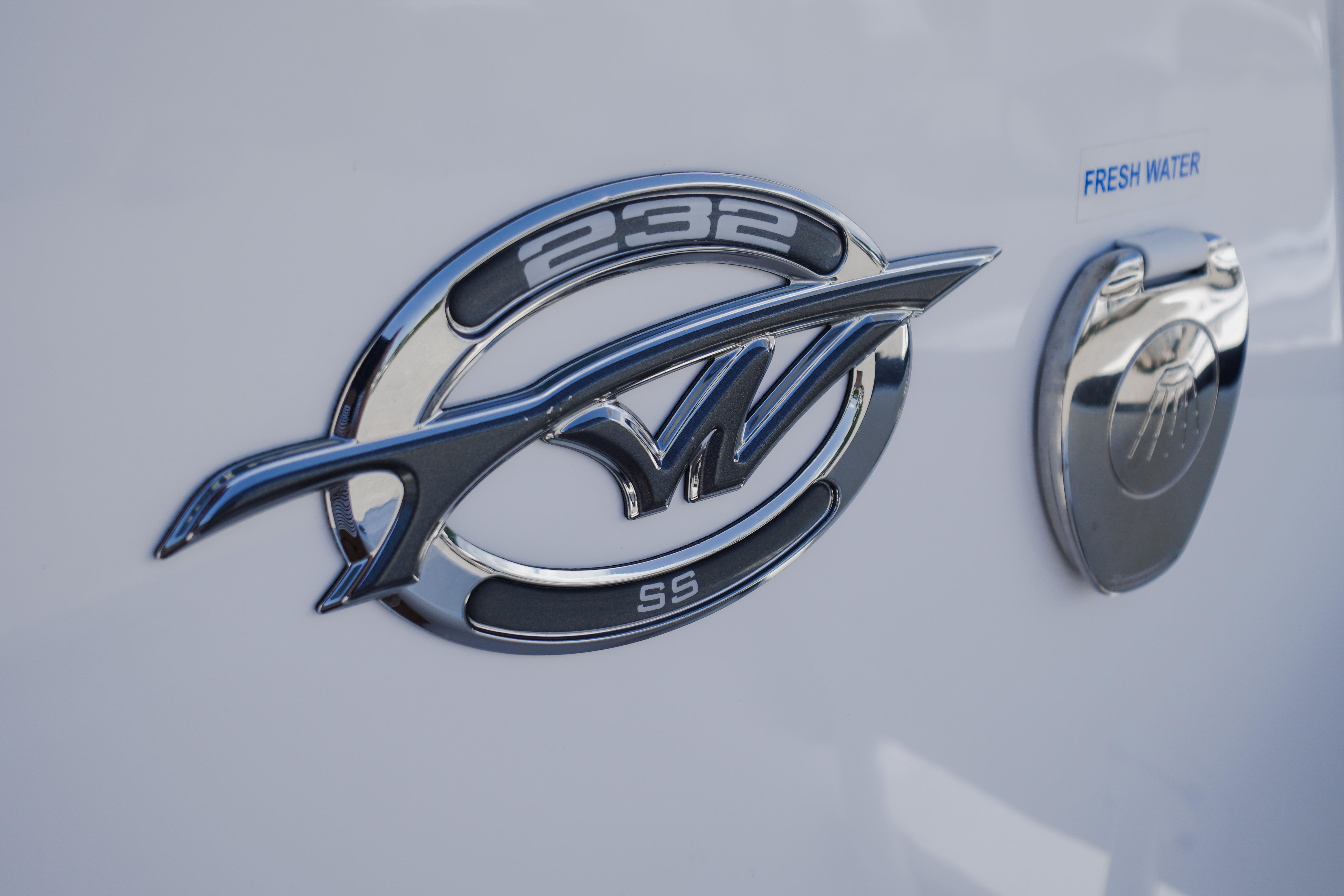 2025 Tidewater 232 SS emblem and fresh water access on boat exterior.