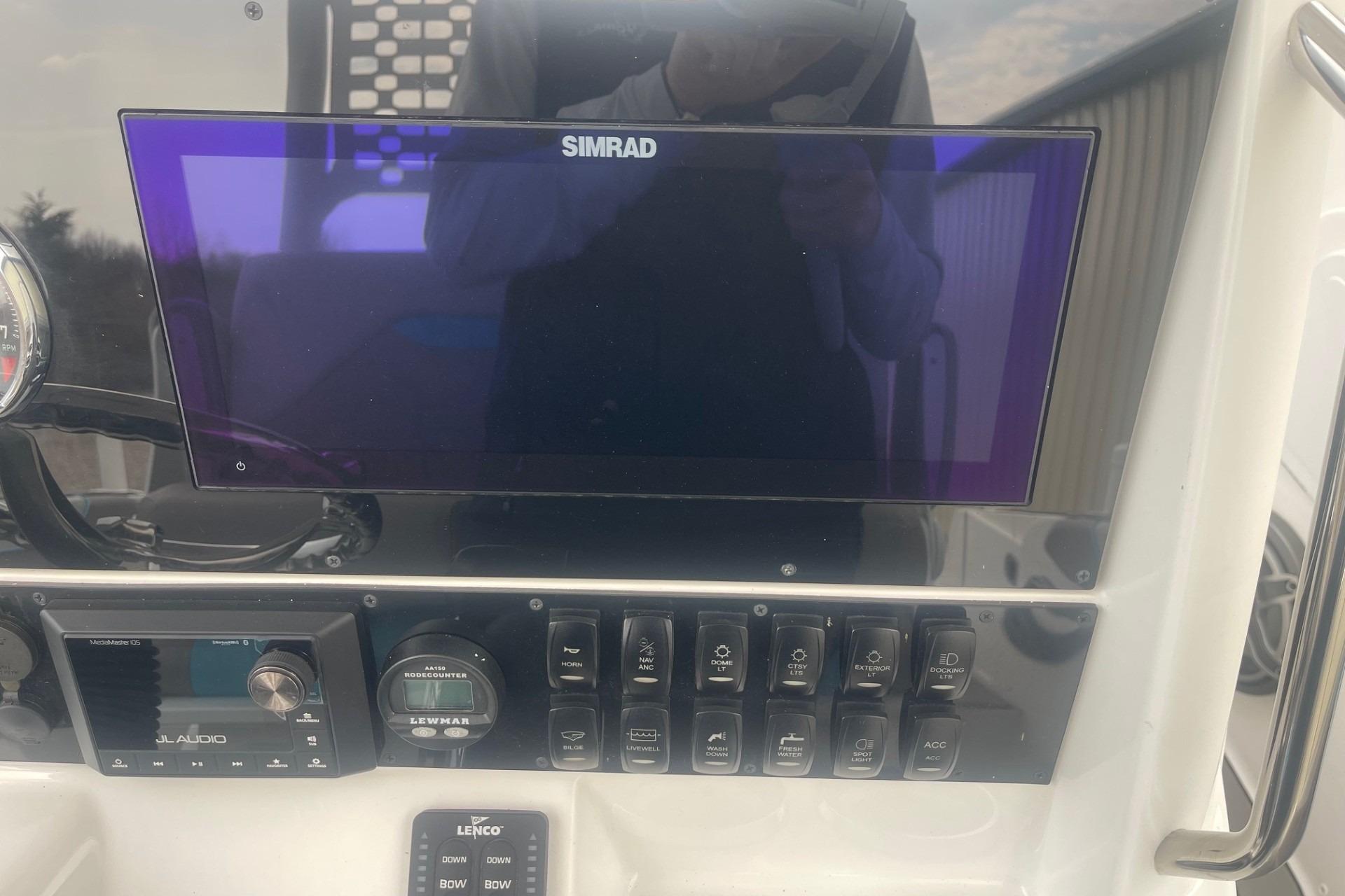2025 Hurricane Center Console 24 OB dashboard with Simrad display and control panel.