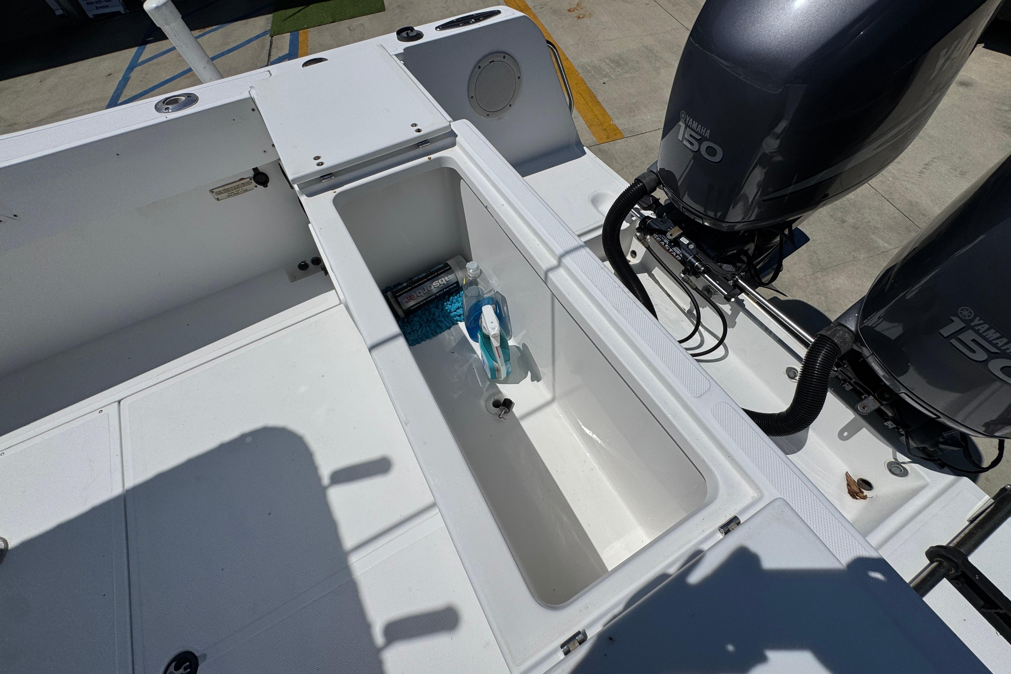 Open storage compartment on 2000 Stamas 250 Tarpon boat with twin Yamaha 150 engines.