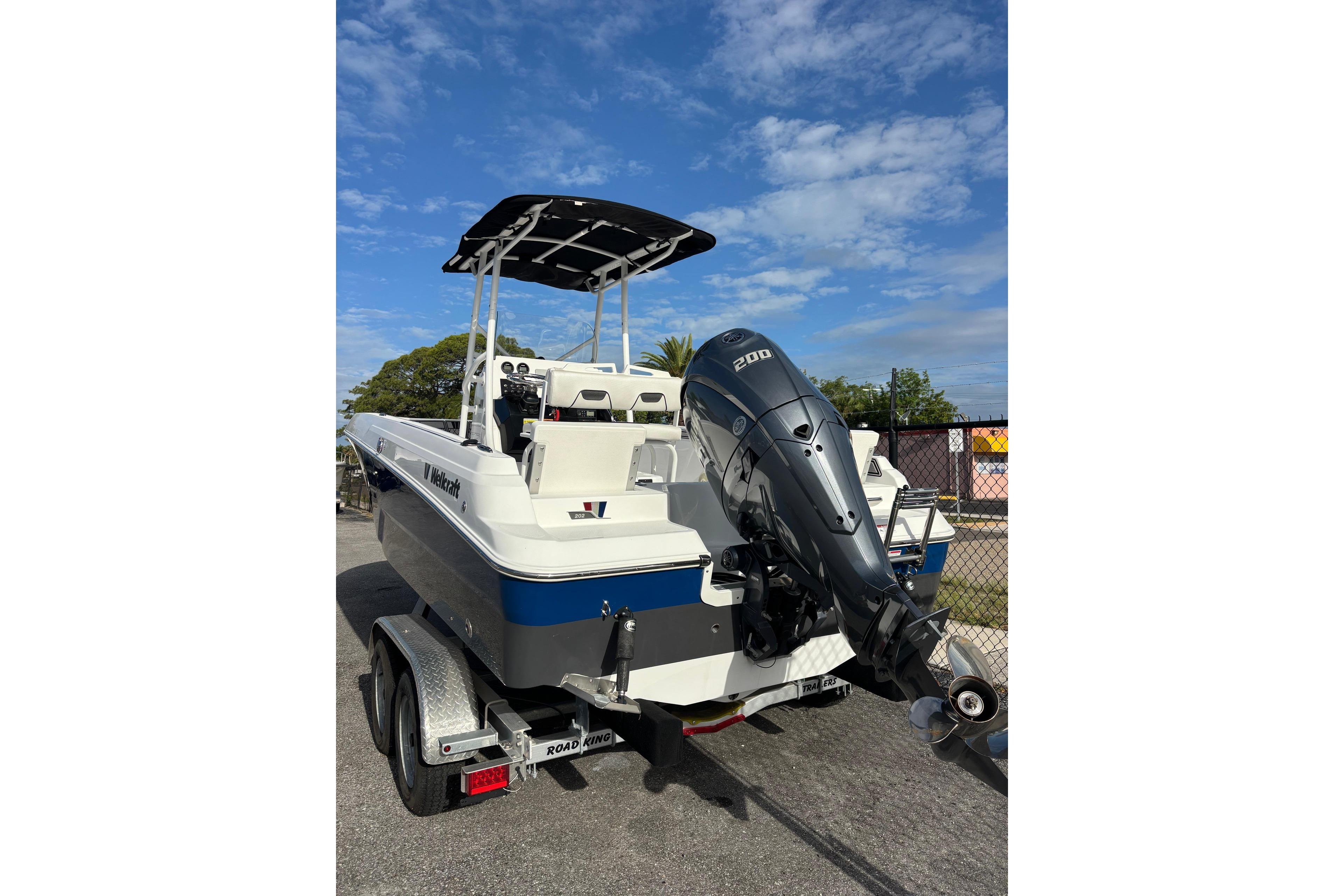 2024 Wellcraft 202 Fisherman boat with powerful outboard motor on a trailer.