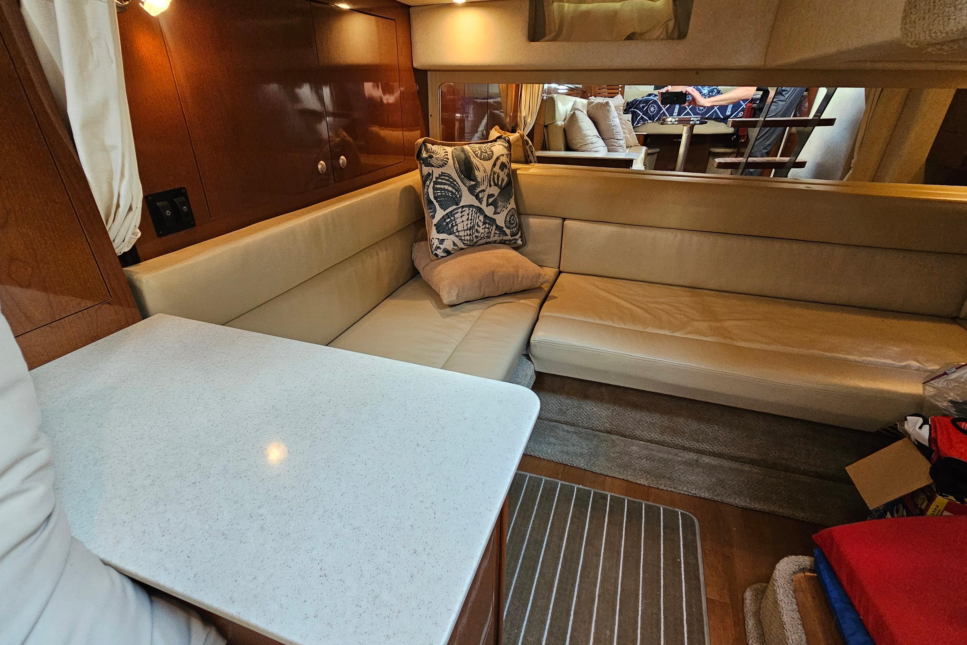 Interior of 2008 Sea Ray Sundancer 350 yacht with beige seating and wooden accents.