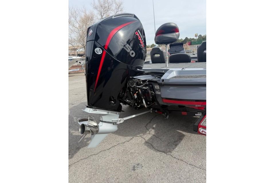 2026 Nitro Z21 XL boat with powerful outboard motor, parked on pavement.