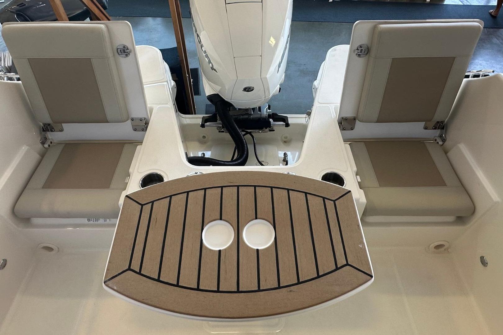 2026 Boston Whaler 210 Vantage boat interior with seating and motor view.