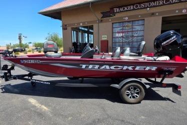 2025 Tracker Pro Team 175 boat in red, parked outside Tracker Customer Care center.