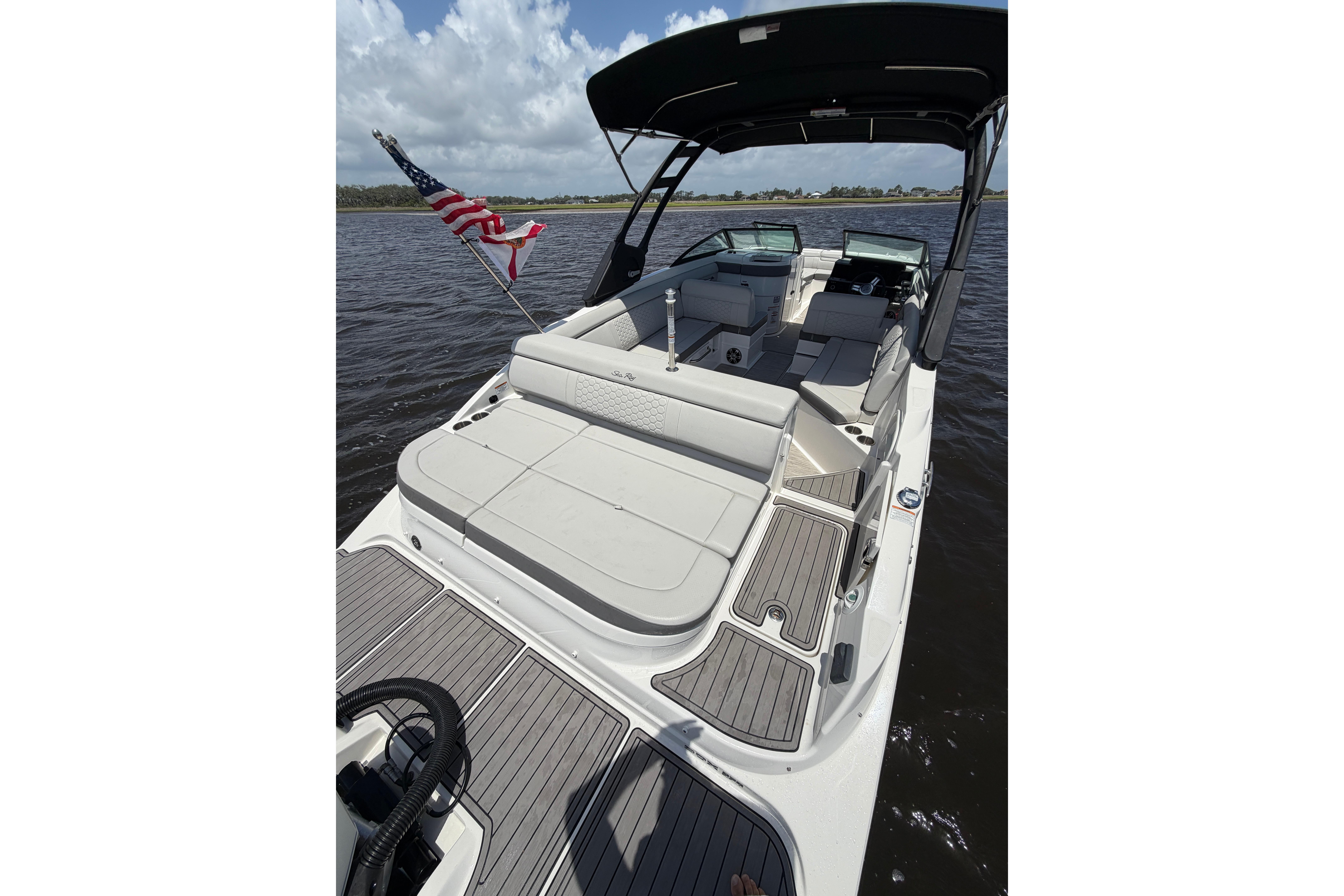 2024 Sea Ray SDX 270 Outboard boat with spacious seating and American flag.