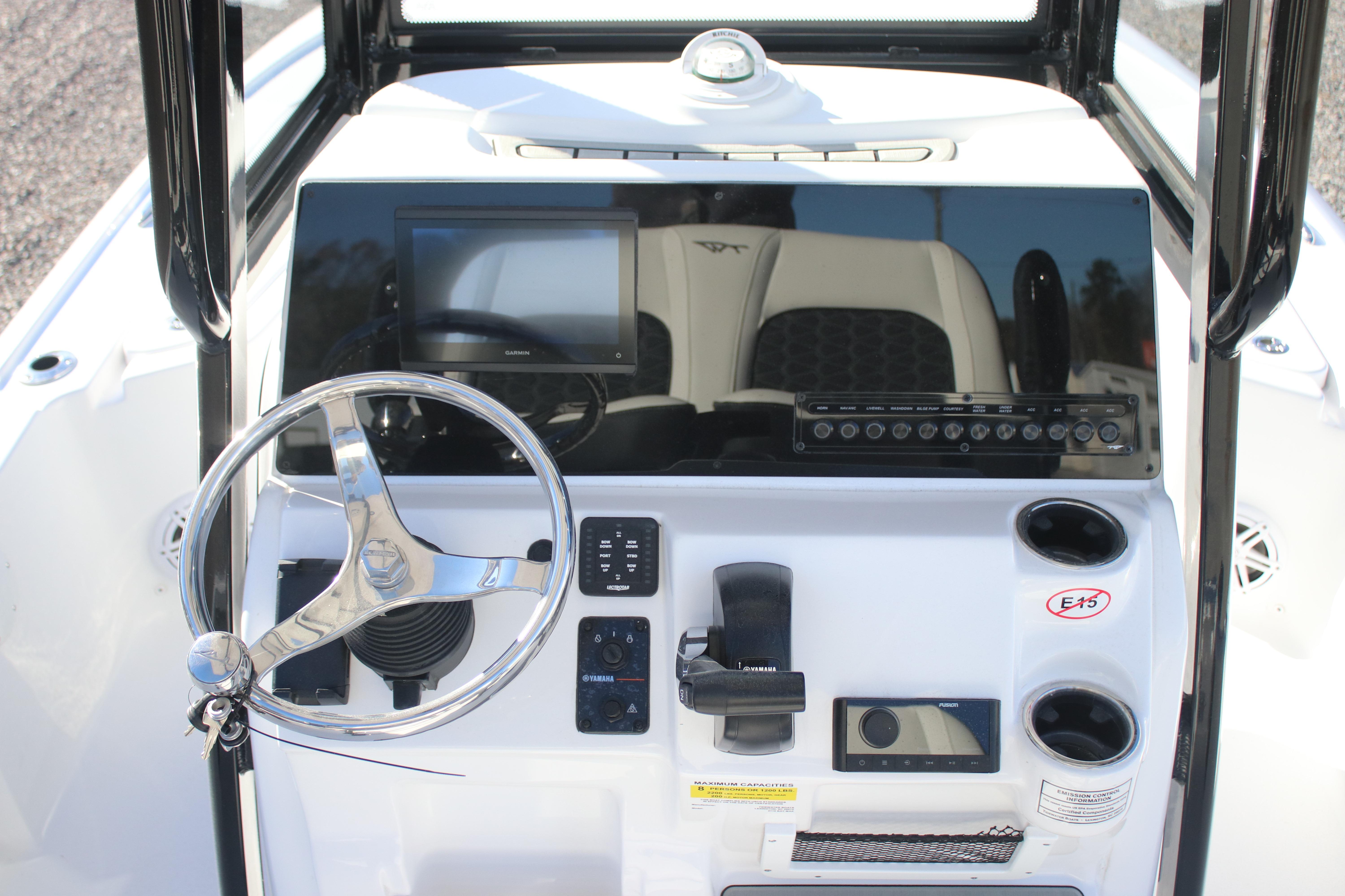 2026 Tidewater 2210 Carolina Bay boat console with steering wheel and electronic controls.