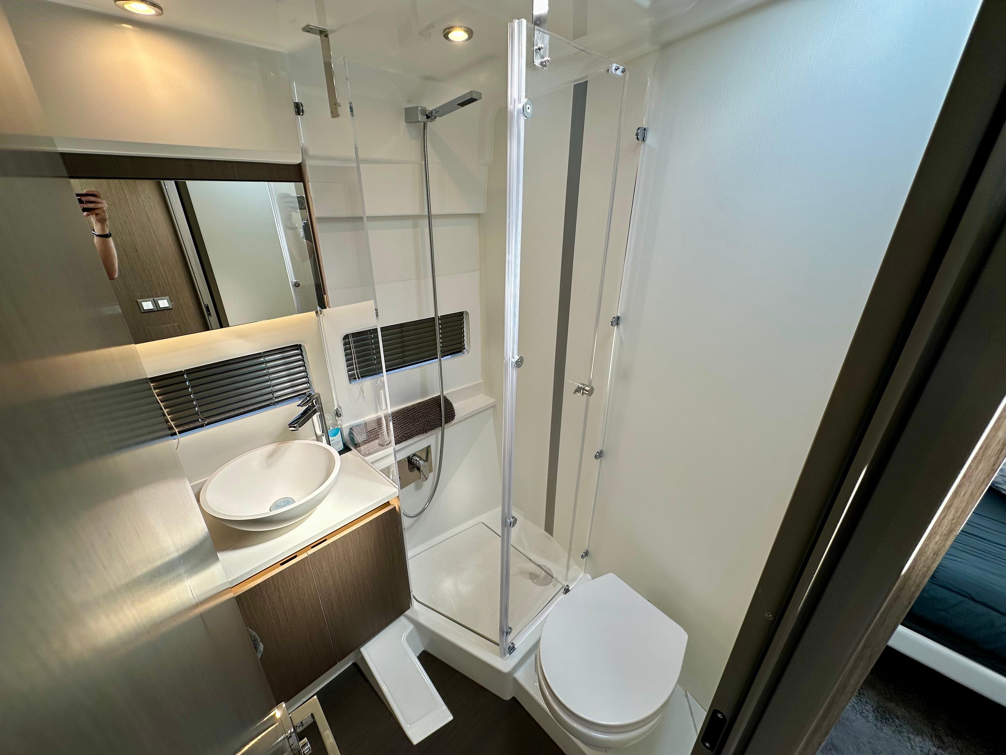 Modern bathroom in 2024 Jeanneau Merry Fisher 1295 Flybridge yacht, featuring sleek design and amenities.