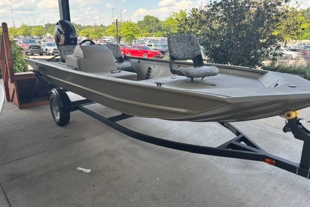 2026 Tracker Grizzly 1754 SC boat on trailer, parked outdoors.